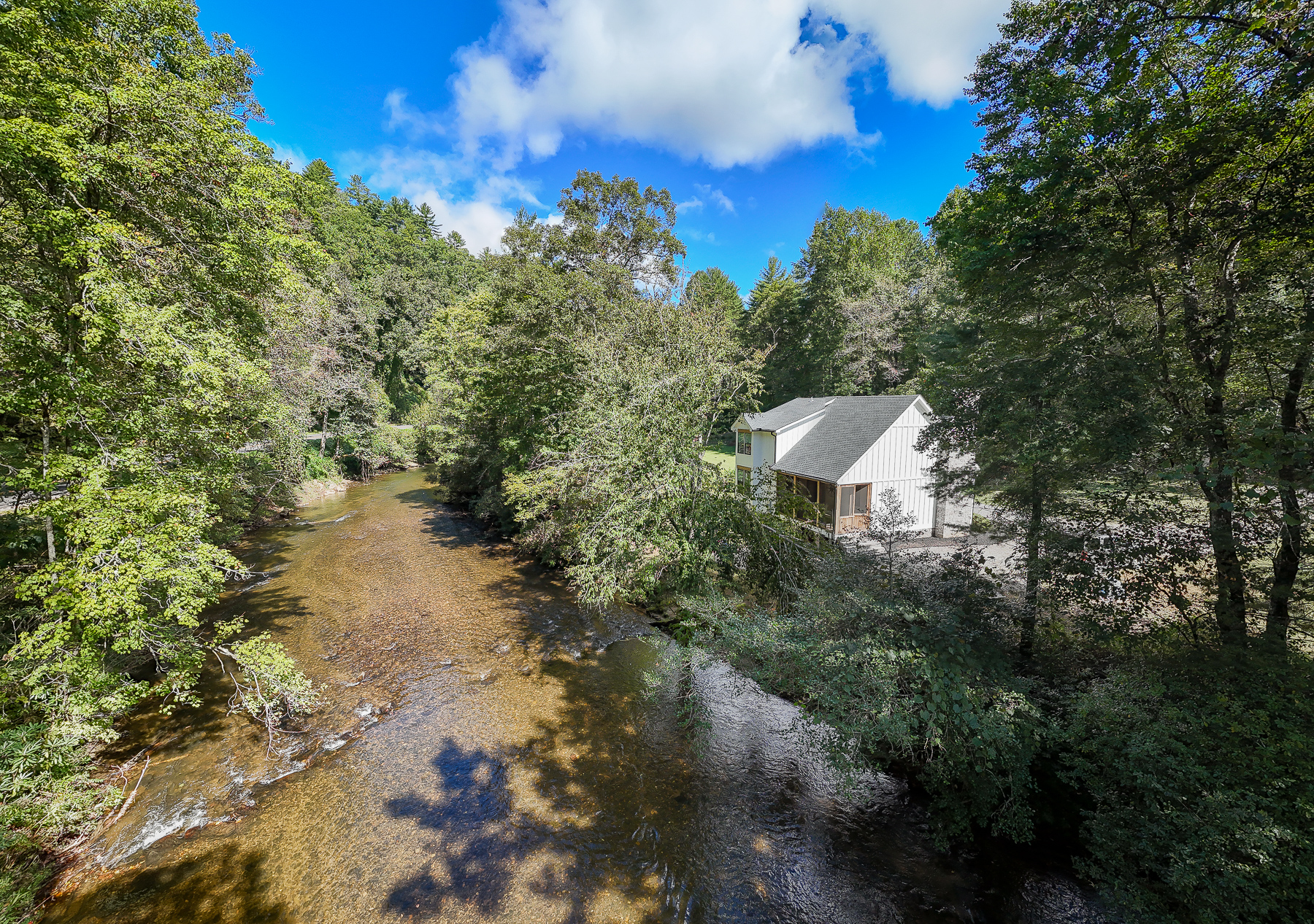 Nestled among leafy trees, Robbin’s Nest on Snowbird Creek sits beside the flowing water for a peaceful creekside getaway.