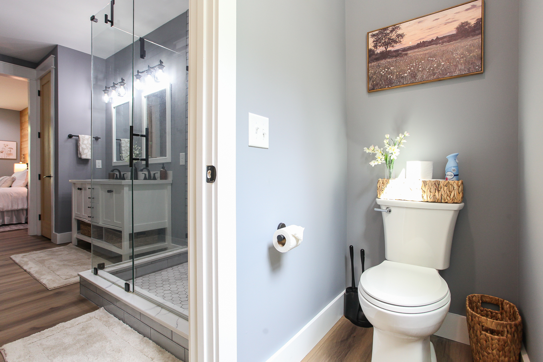 The primary bathroom at Robbin’s Nest on Snowbird Creek includes a separate toilet room for added privacy beside the glass-enclosed shower.