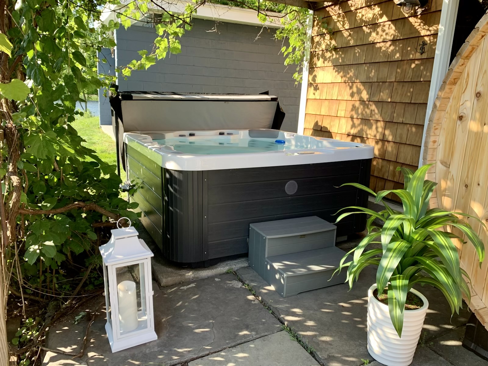 Your private River Spa Patio features a premium hot tub, cedar barrel sauna, and a secluded space to relax after a day on the water.
