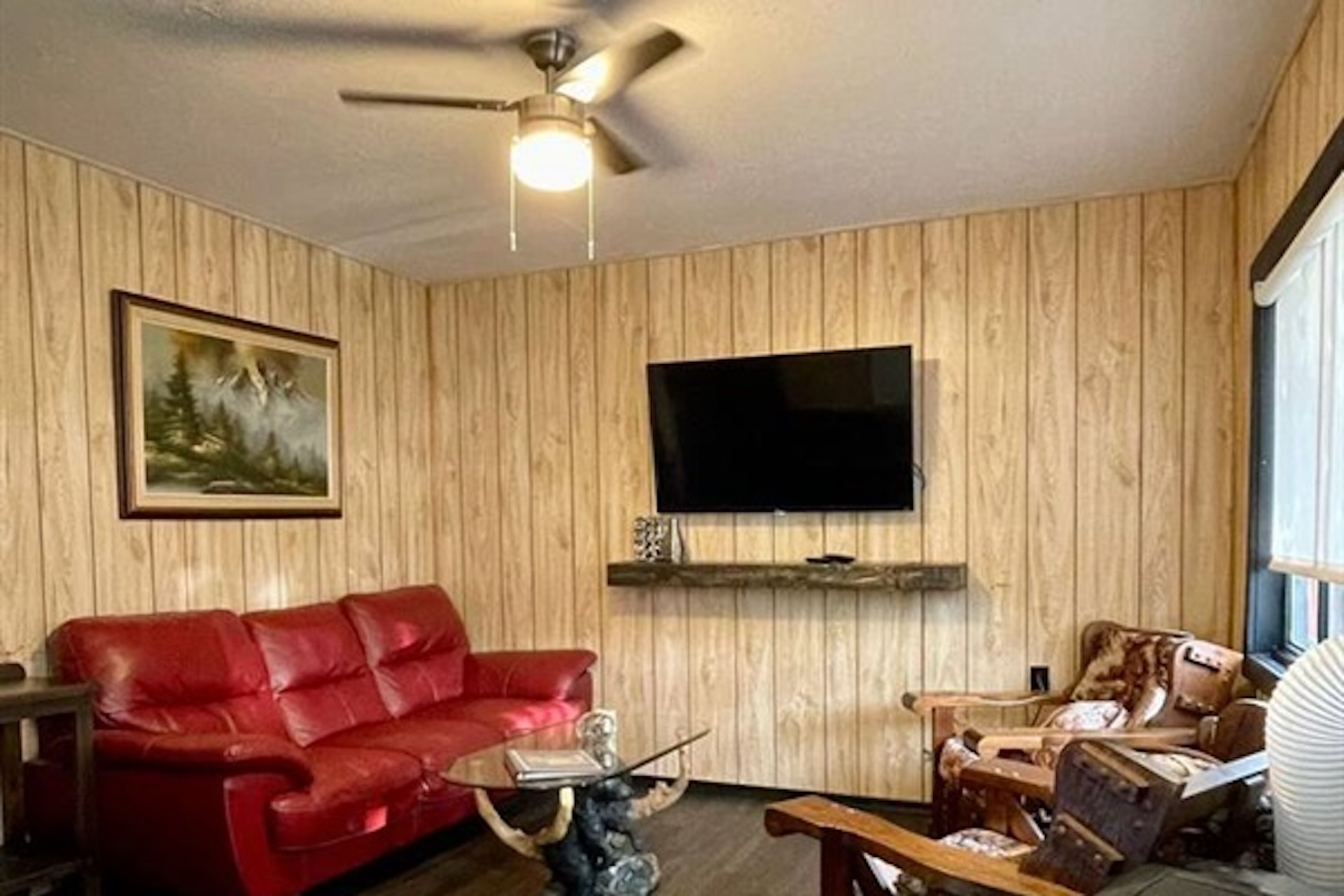 Living room with wall-mounted TV and comfortable seating