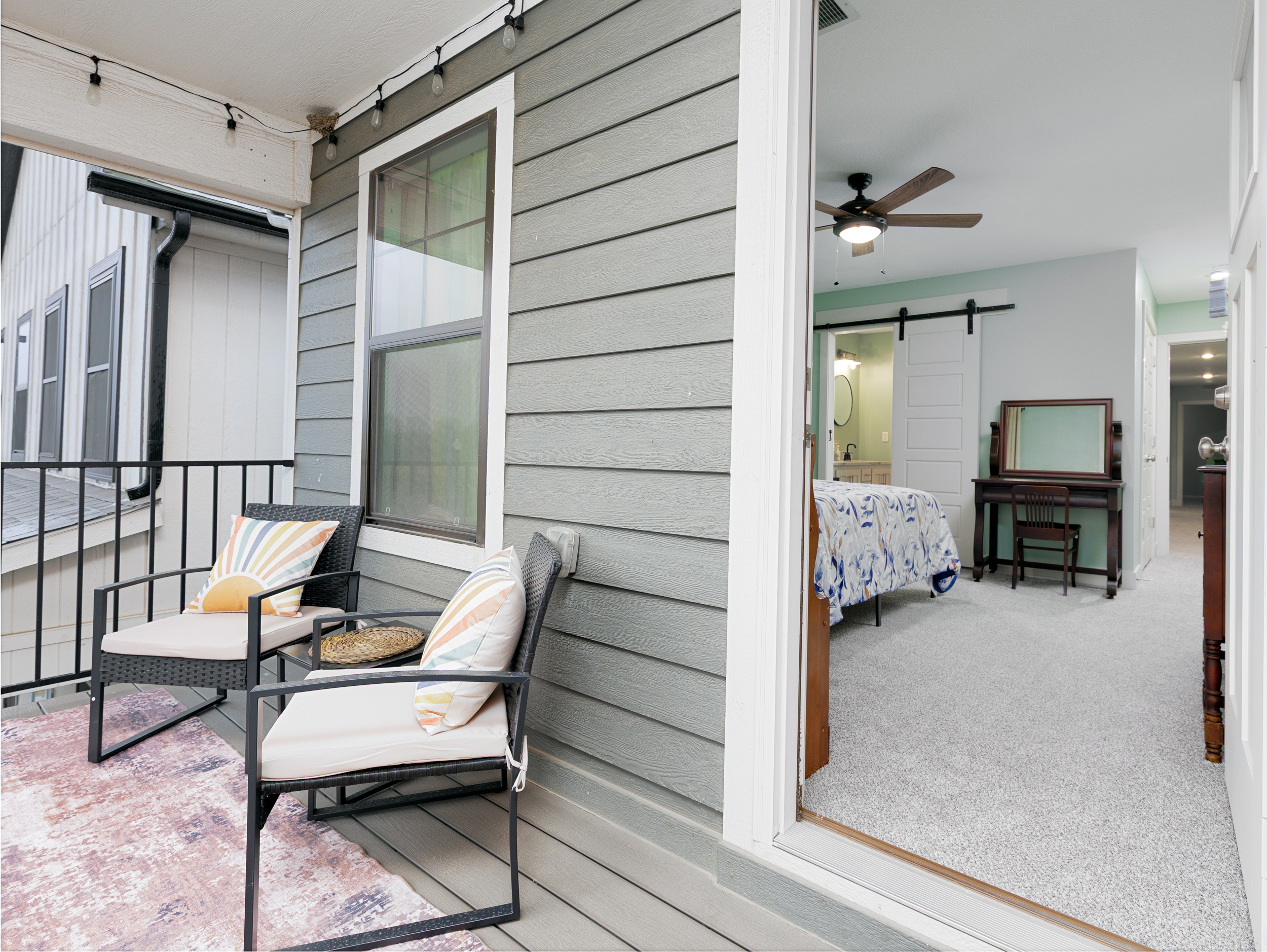 Private balcony off the primary bedroom with comfortable seating for a quiet outdoor escape.