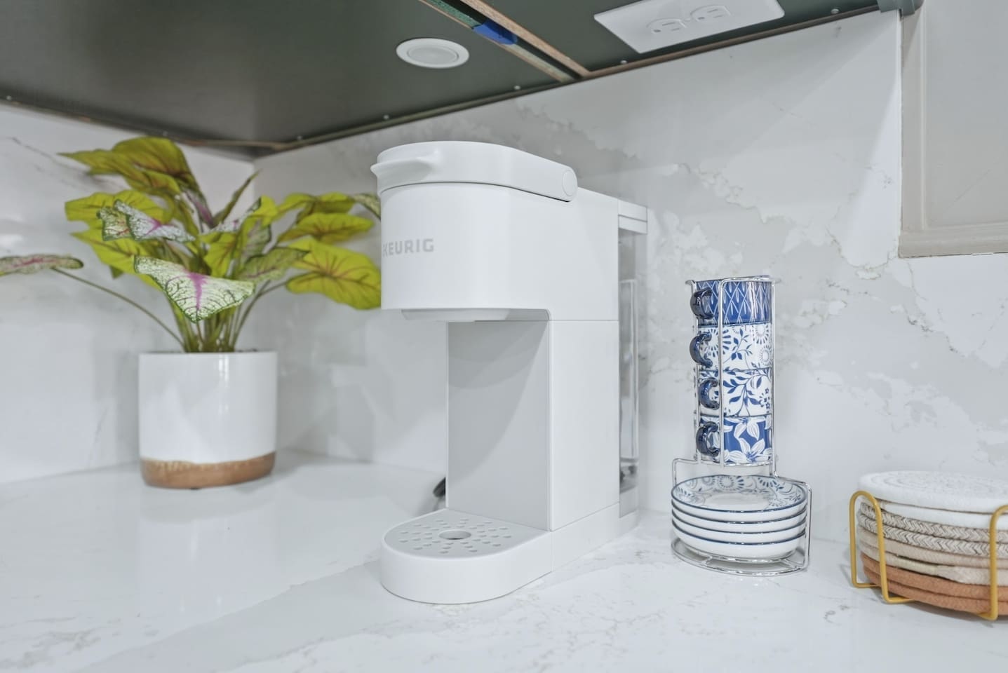 Coffee lovers will appreciate the Keurig setup with mugs and pods ready for a fresh cup whenever you need it.