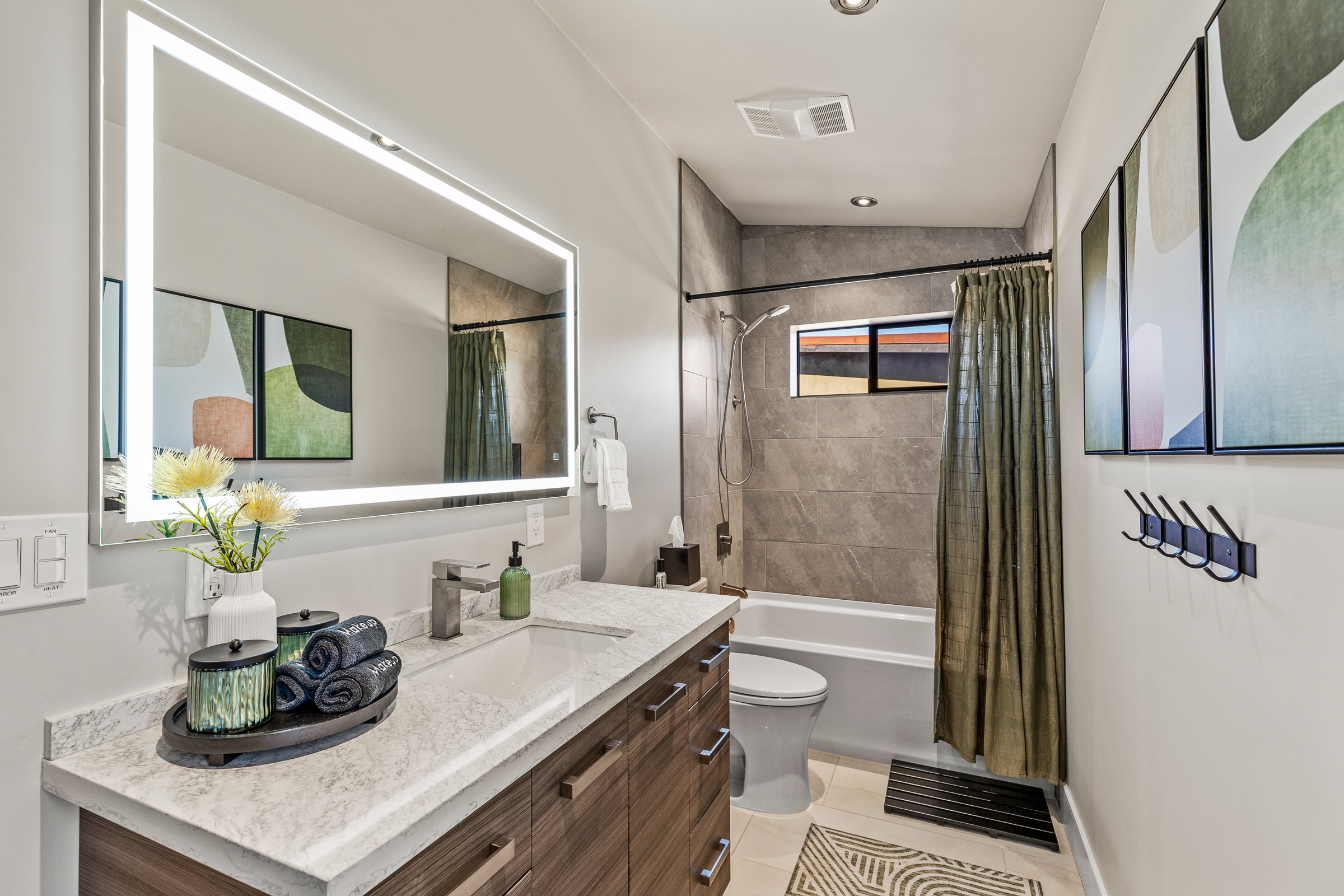 A bright, well-appointed bathroom with a spacious vanity and a tub-shower combination, designed for easy mornings and relaxed evenings.