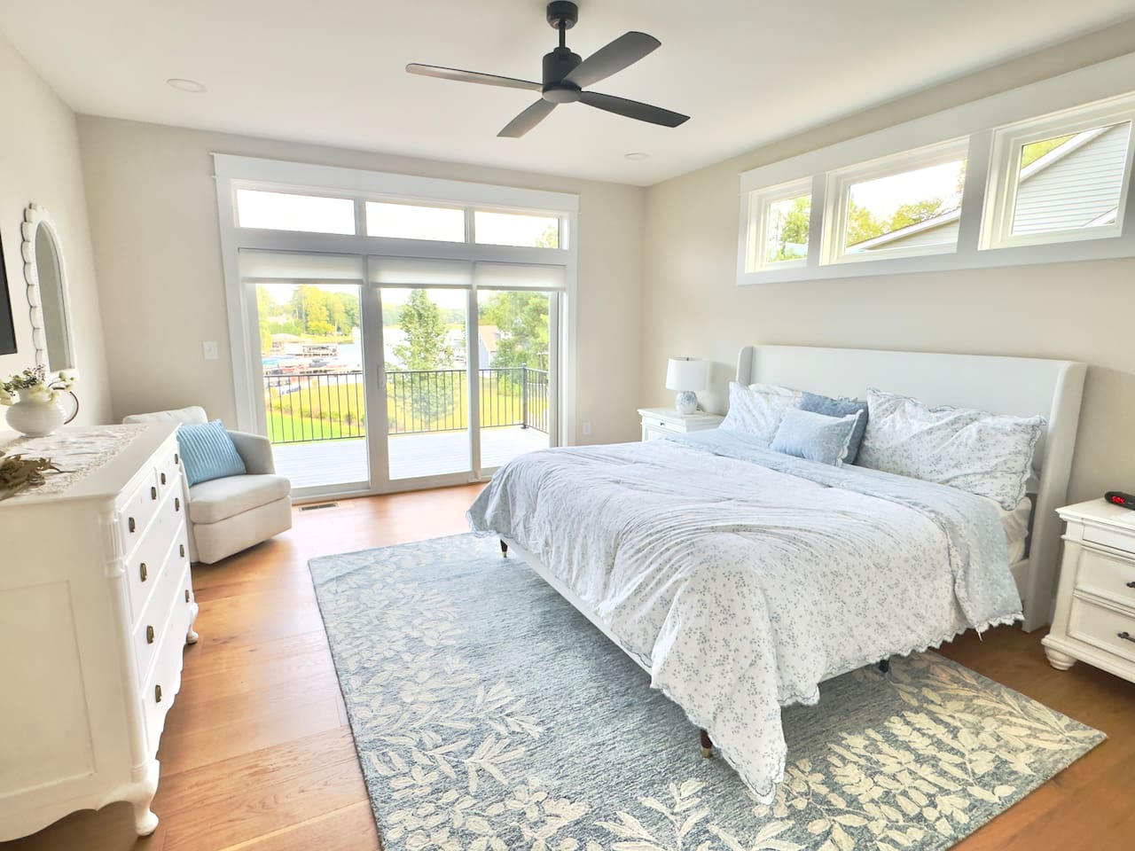 The main king suite is an indulgent retreat wrapped in layers of crisp whites and blues that mirror the tranquility of the lake,elevated with refined details, antique touches & plush bedding & feels like a private retreat where elegance meet serenity