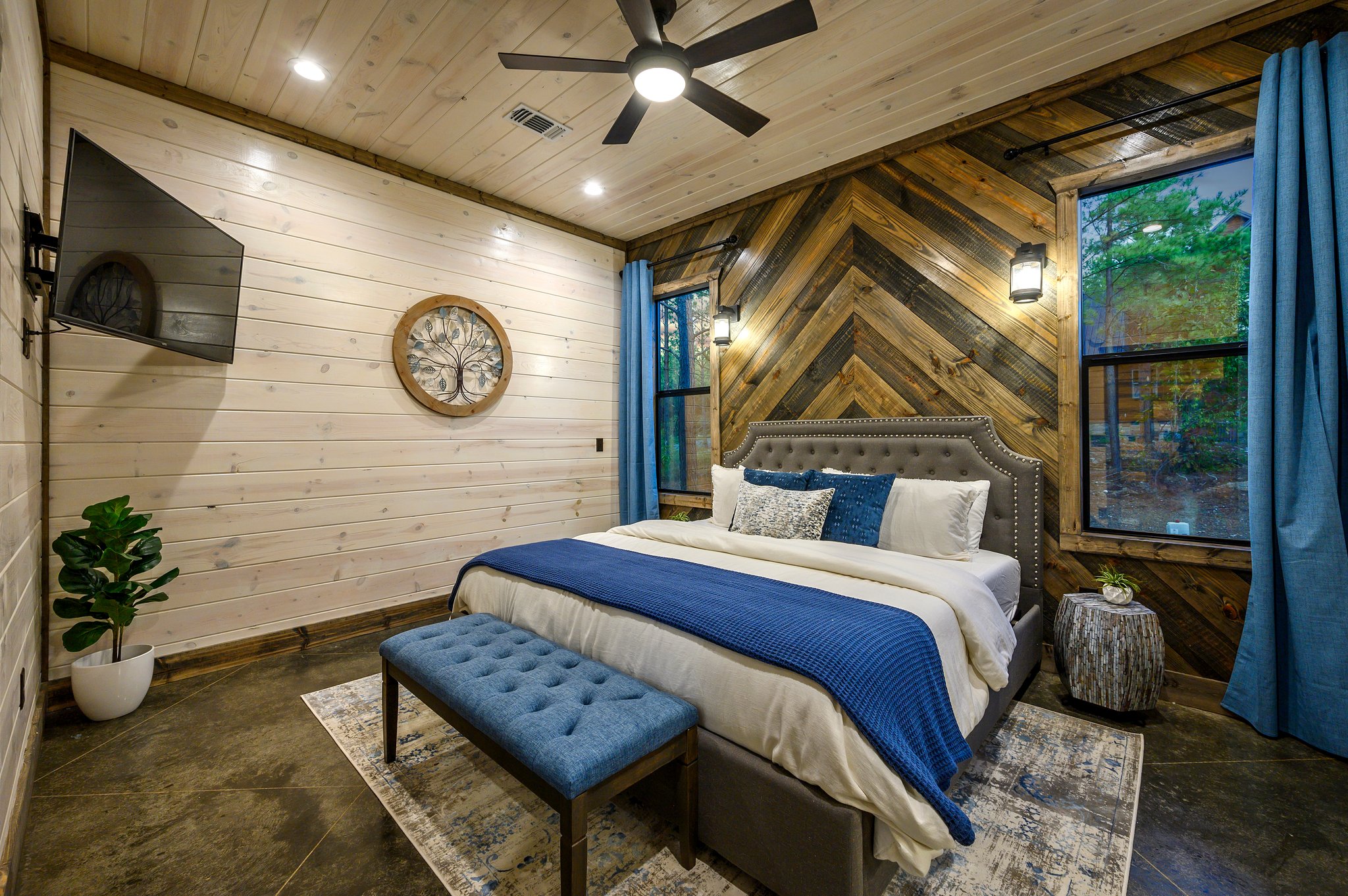 Designer king suite featuring a stunning custom chevron wood wall.