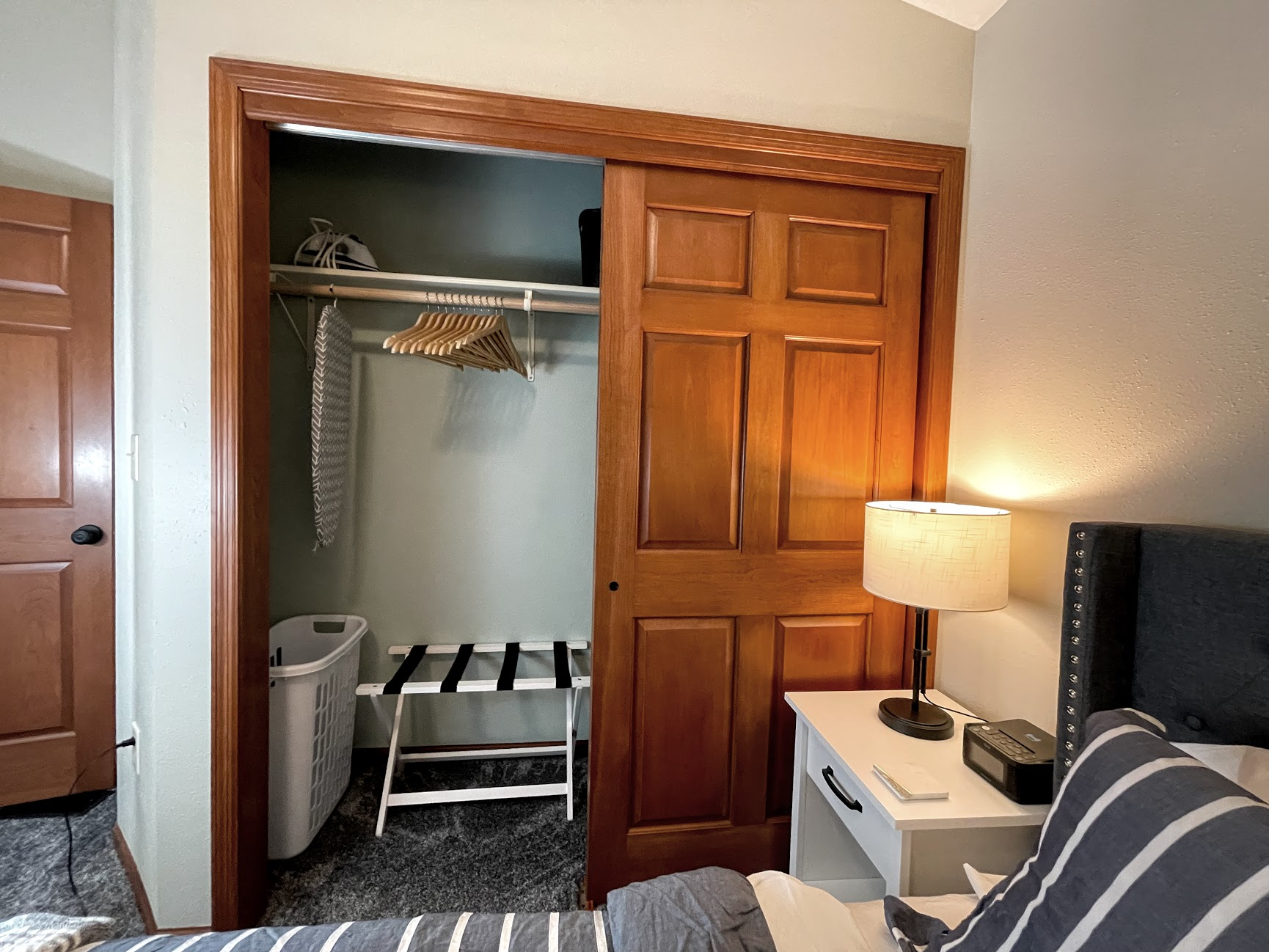 Master closet main cottage with bedding for queen living room couch sofa sleeper, Iron board, extra chairs (2) for butterfly leaf, hangers, laundry basket, luggage rack