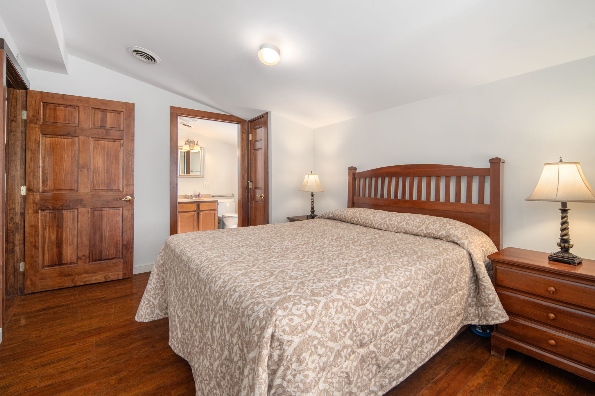 This queen bedroom offers convenient access to its adjoining bathroom.