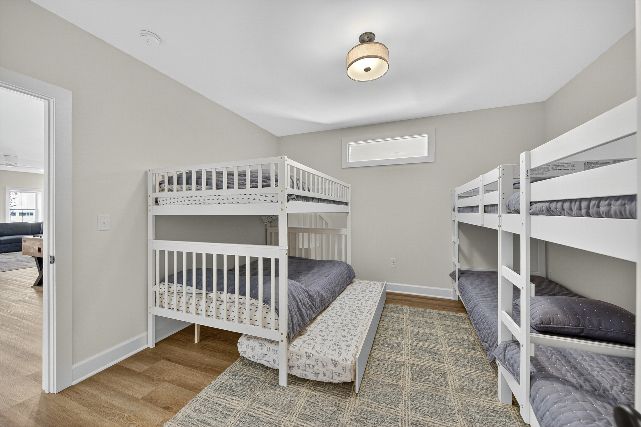 Two double beds, two twin bunks, and an extra twin trundle make this the ultimate kids' hangout.