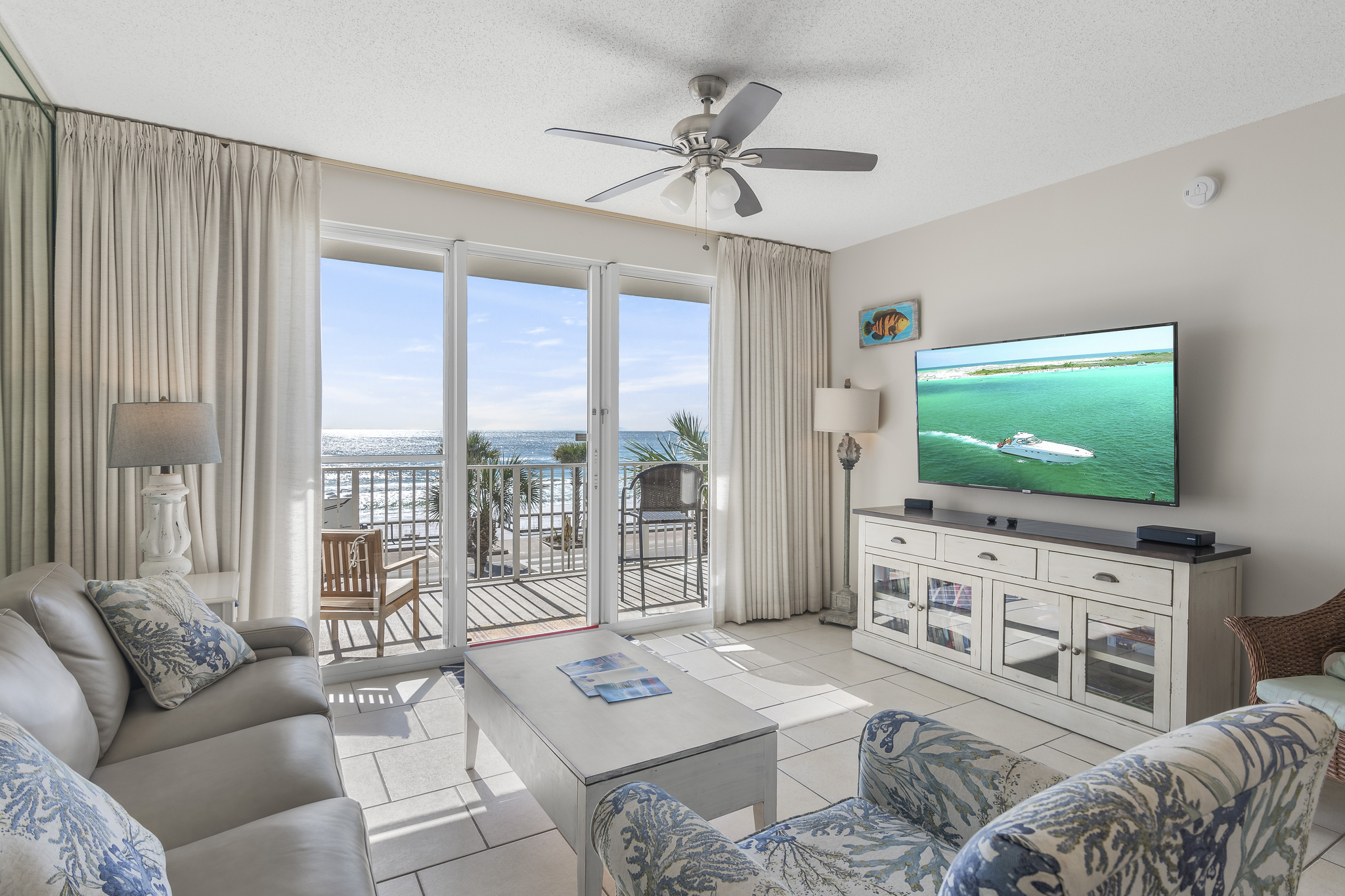 Beautiful, bright, and open living and dining space with tall ceiling, Gulf views, and comfortable furniture around a large Smart TV for Netflix, Prime TV, etc.