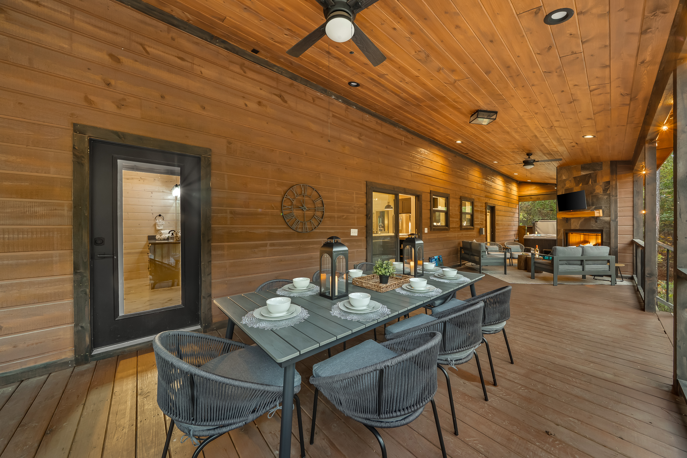 Another angle of the covered deck showing plenty of room to gather, unwind, and enjoy fresh forest air.