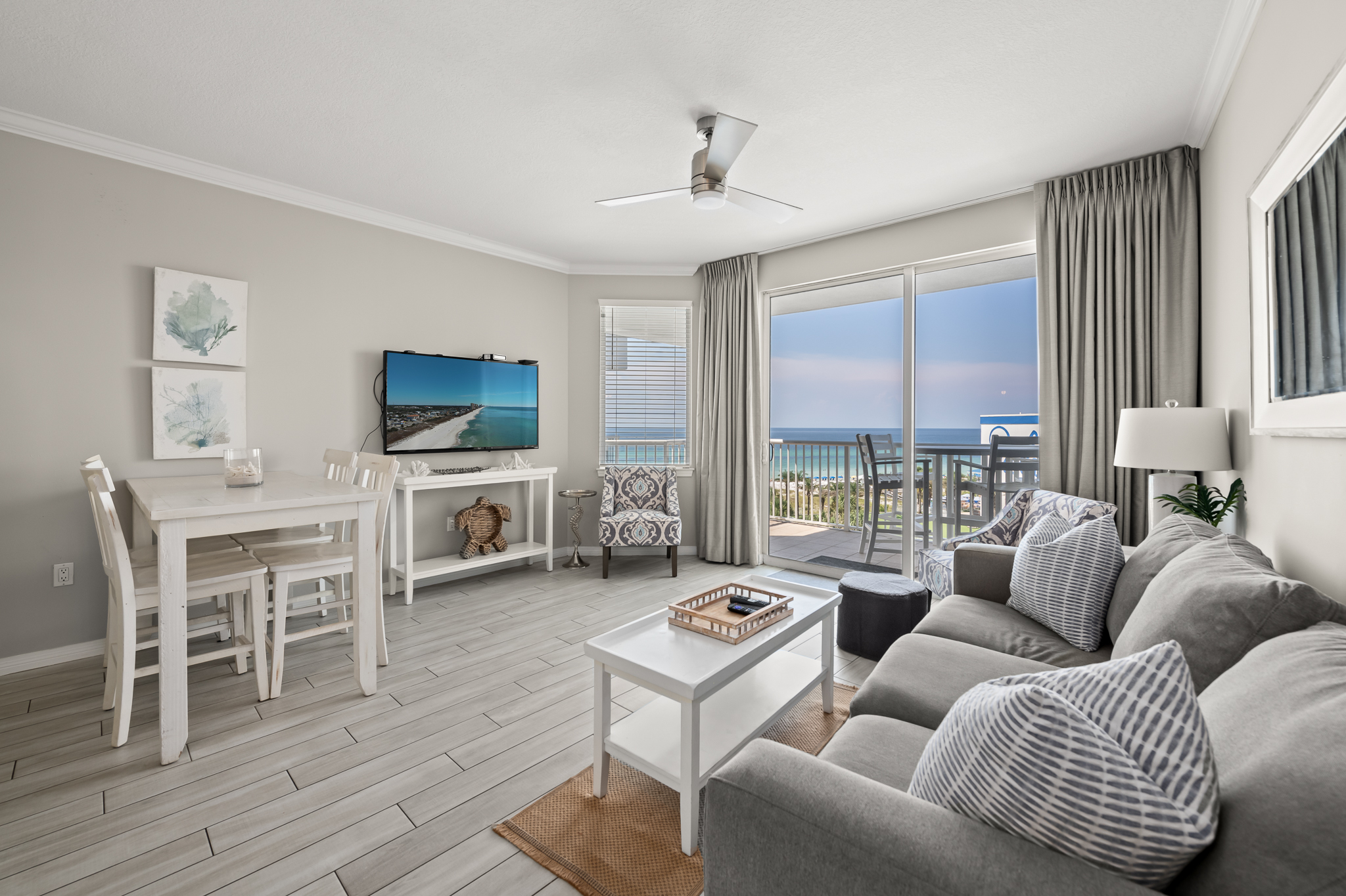 Open living space w/ comfy seating and coastal tones, ideal for relaxing together.