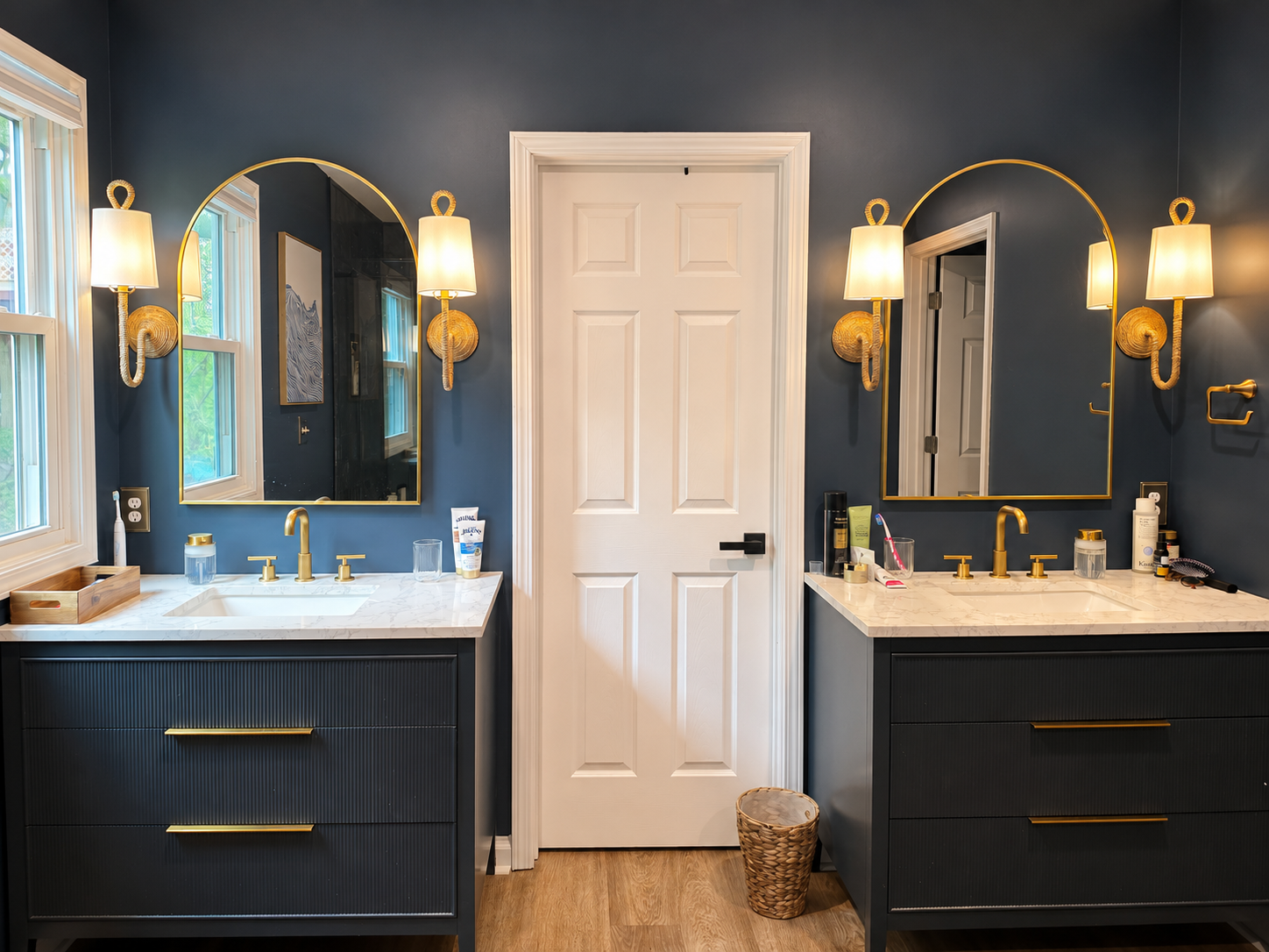 Spacious primary bathroom with dual vanities, warm lighting and plenty of room to get ready.