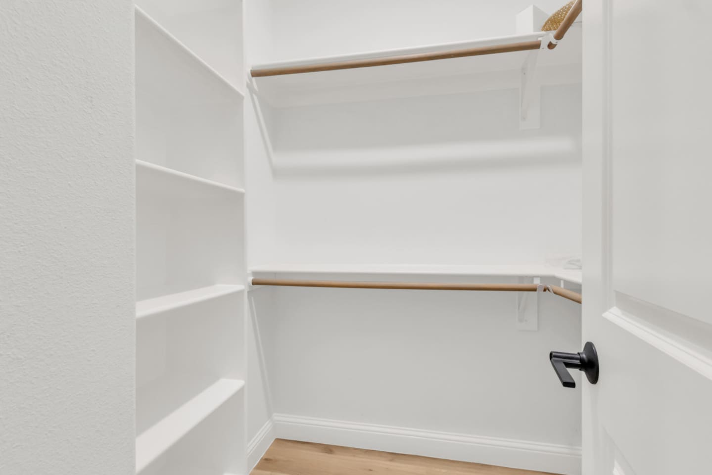 Large walk-in closet with open shelving and hangers for convenience.