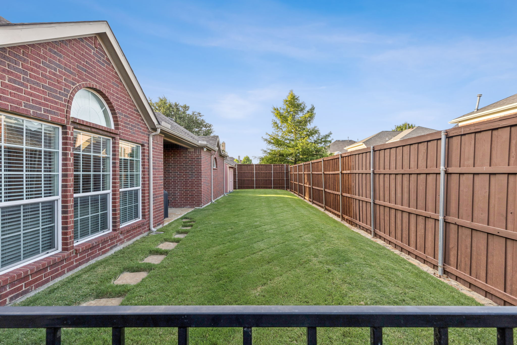 Covered patio with grill and grassy play space for your kids or furbabies.