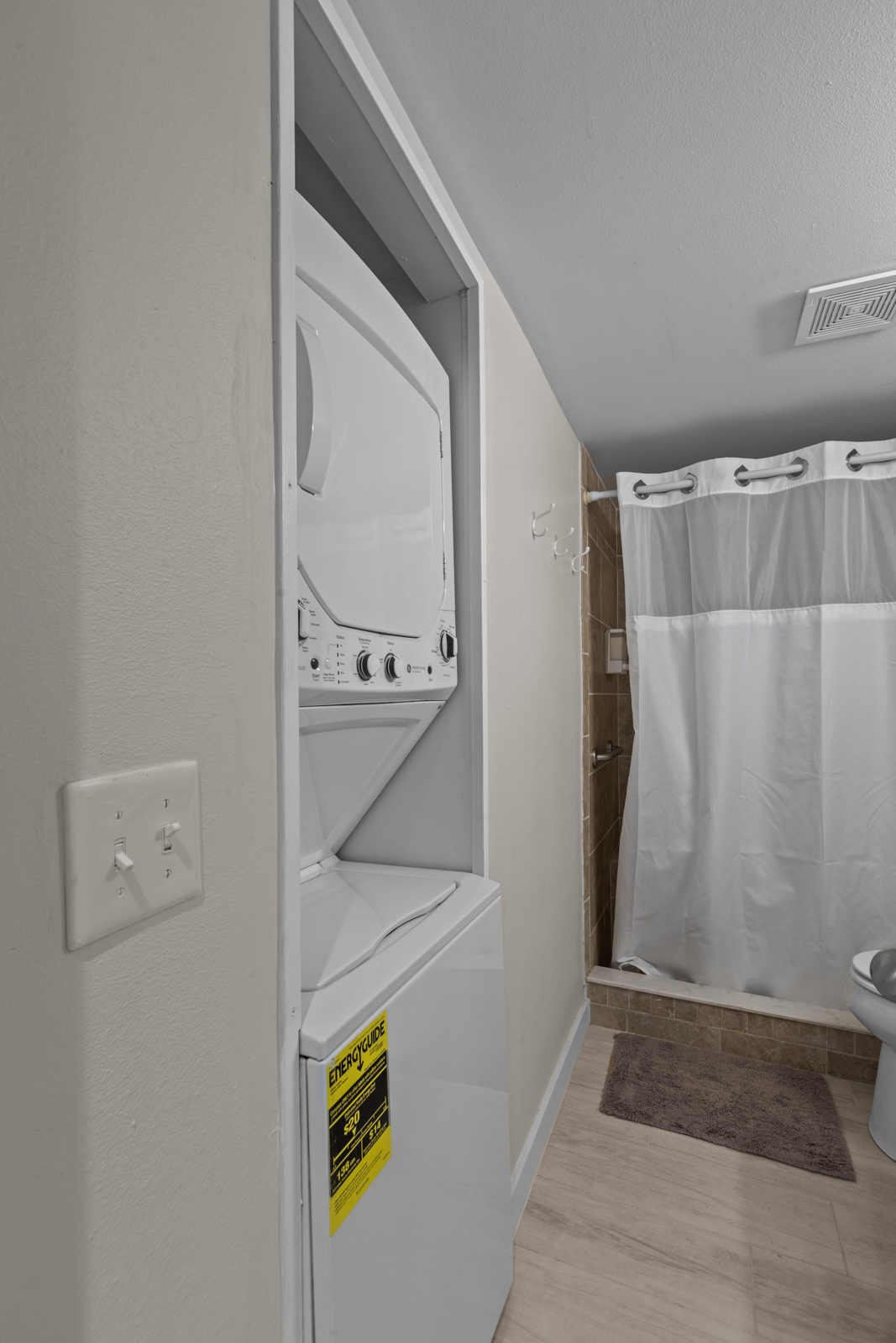 Washer and Dryer located in bathroom.