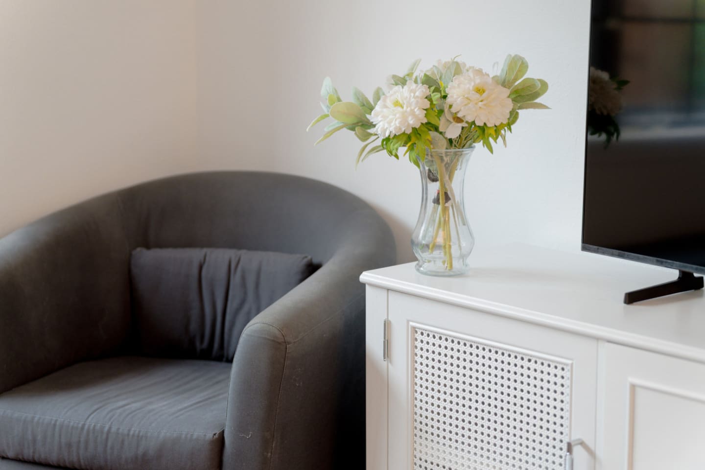 Living area with direct backyard access and cozy seating.