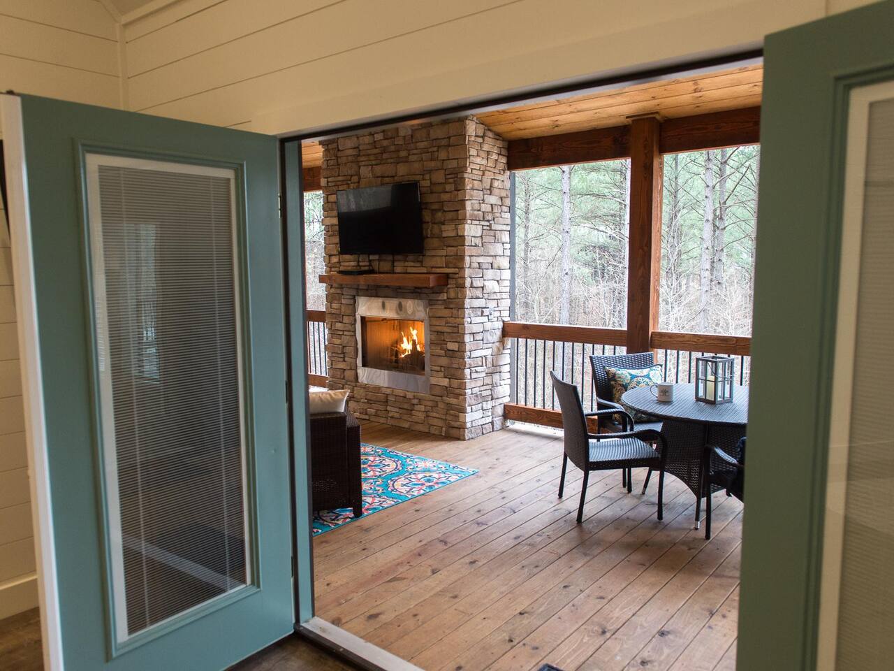 Main Bedroom: Step outside to your private retreat with a fireplace and serene woodland views!