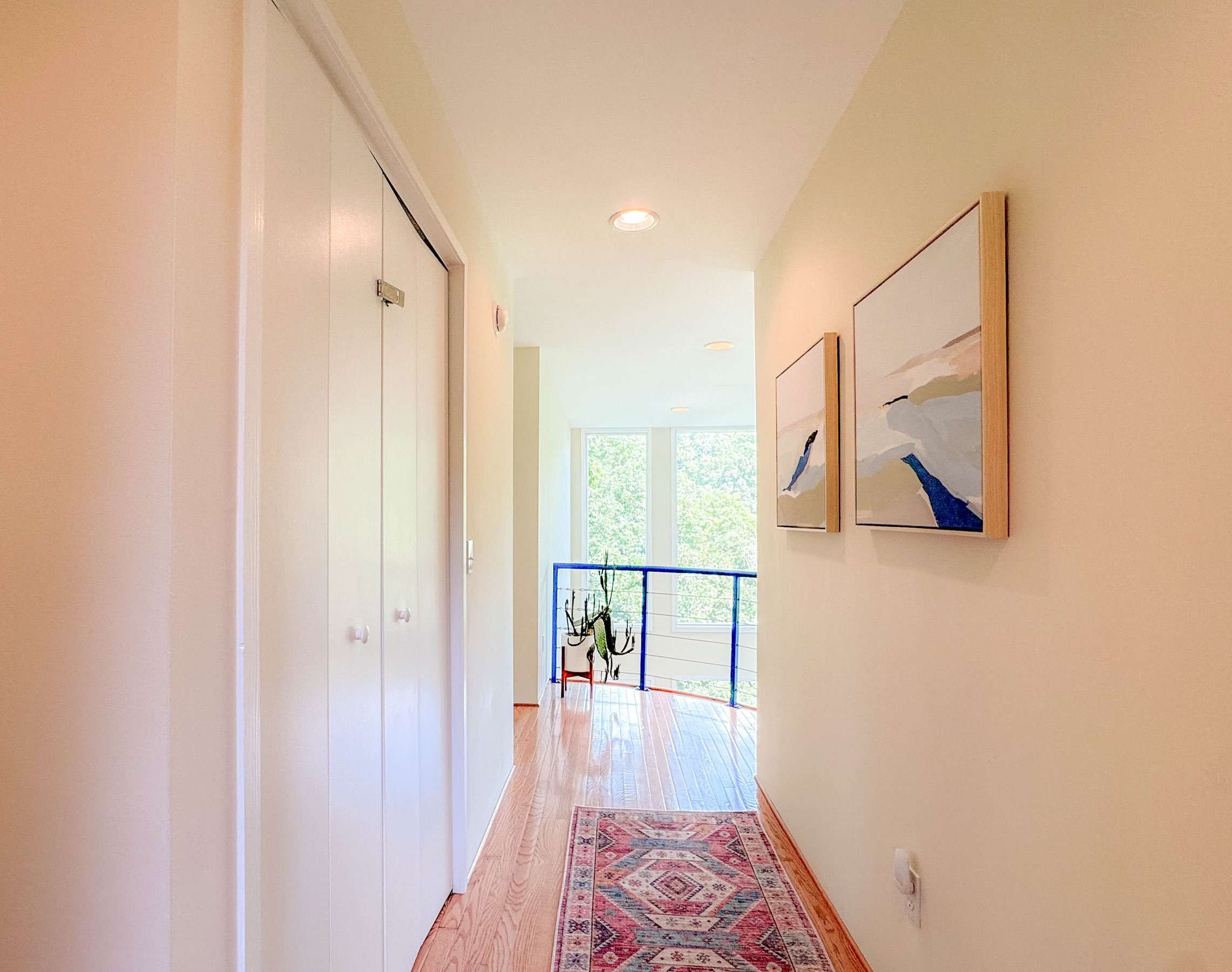 Upstairs hallway leading to upstairs bedroom 2. The balcony overlook is a wonderful touch to the property.