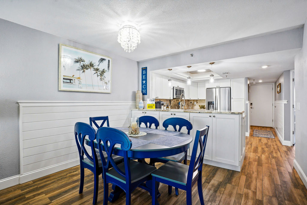 Coastal dining area in this beachfront vacation rental, perfect for family meals with easy access to the modern kitchen.