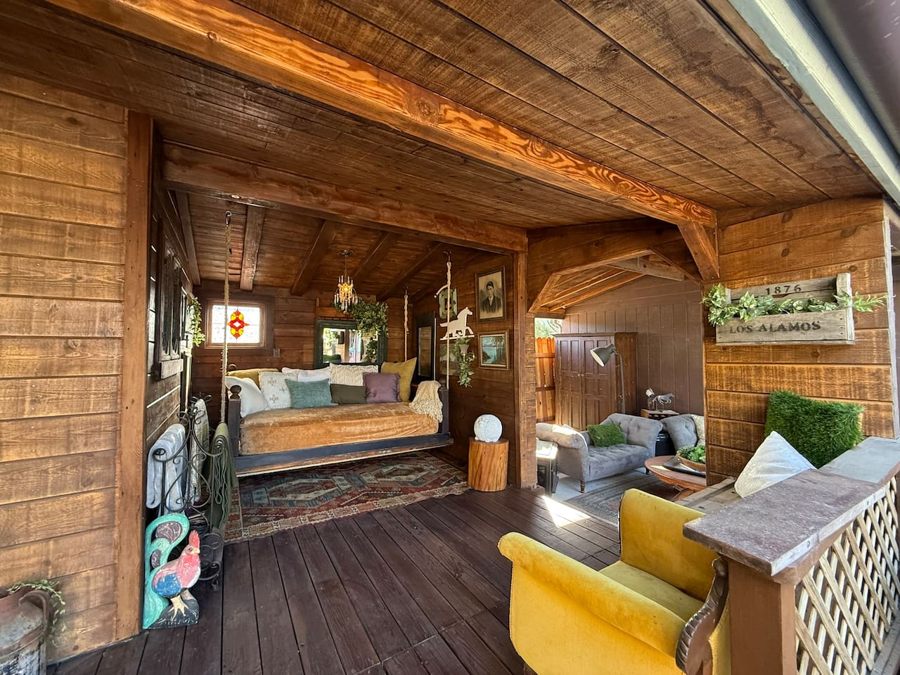 The covered porch unfolds like an outdoor living room, with intimate seating nooks, vintage finds and the full-size Bali swing bed. Grab a blanket, cue up karaoke or challenge someone to paddleball—then claim your corner and stay awhile.