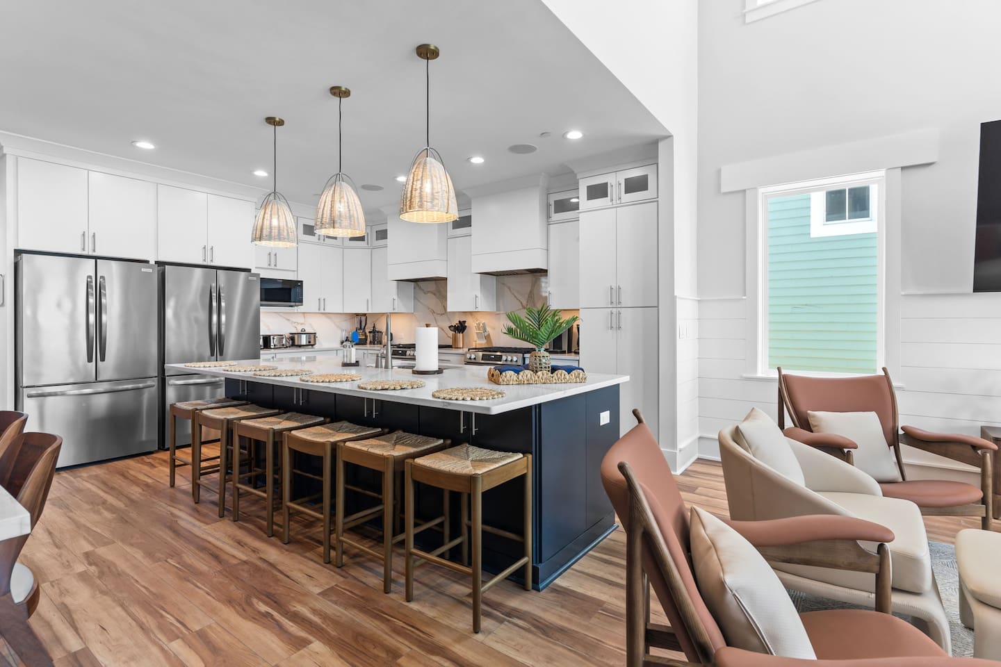 The heart of the home. This open-concept kitchen connects seamlessly to the living and dining areas, while the adjacent oceanfront deck offers additional seating for meals with a view.