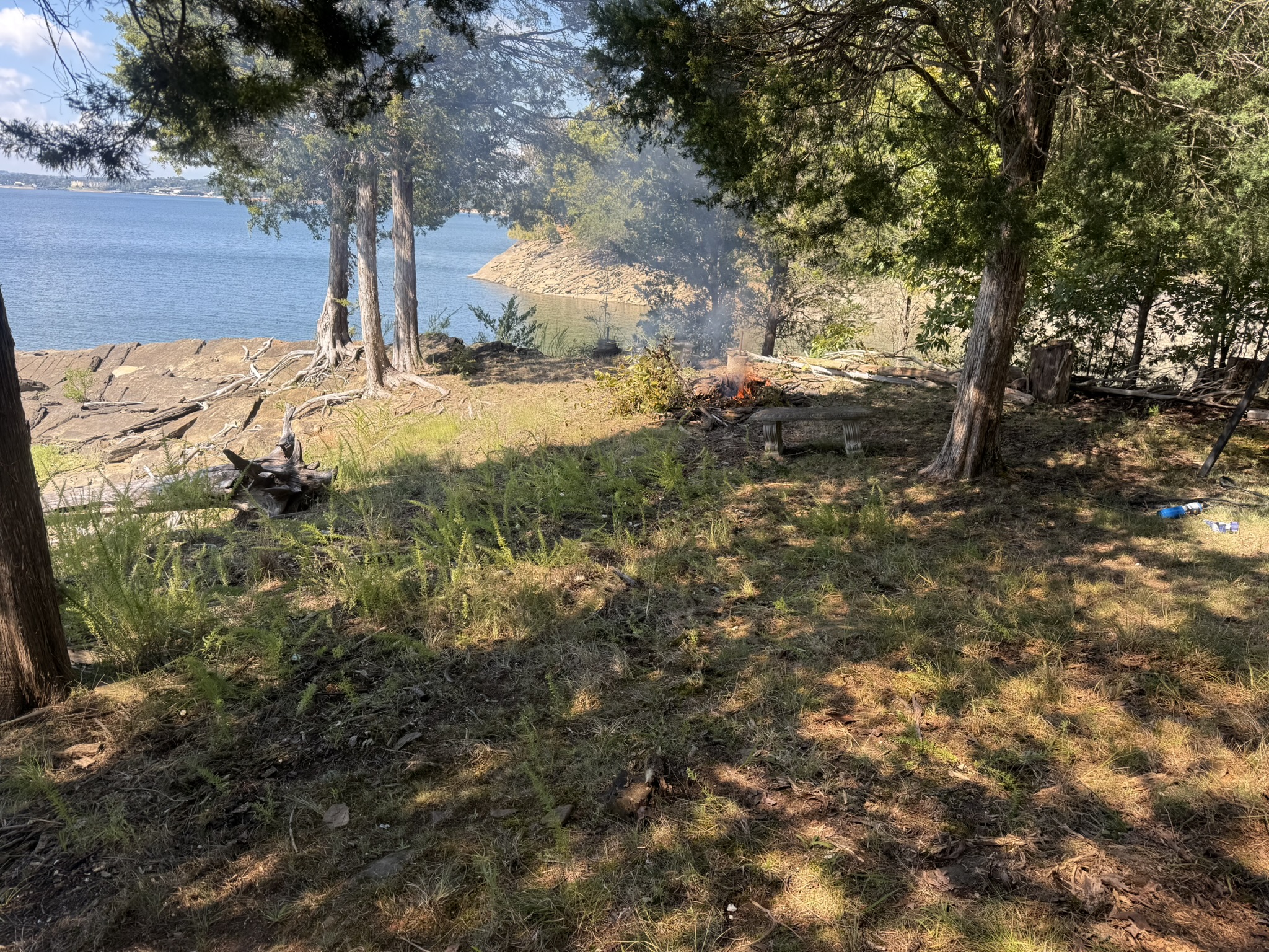 Firepit and seating area next to lake