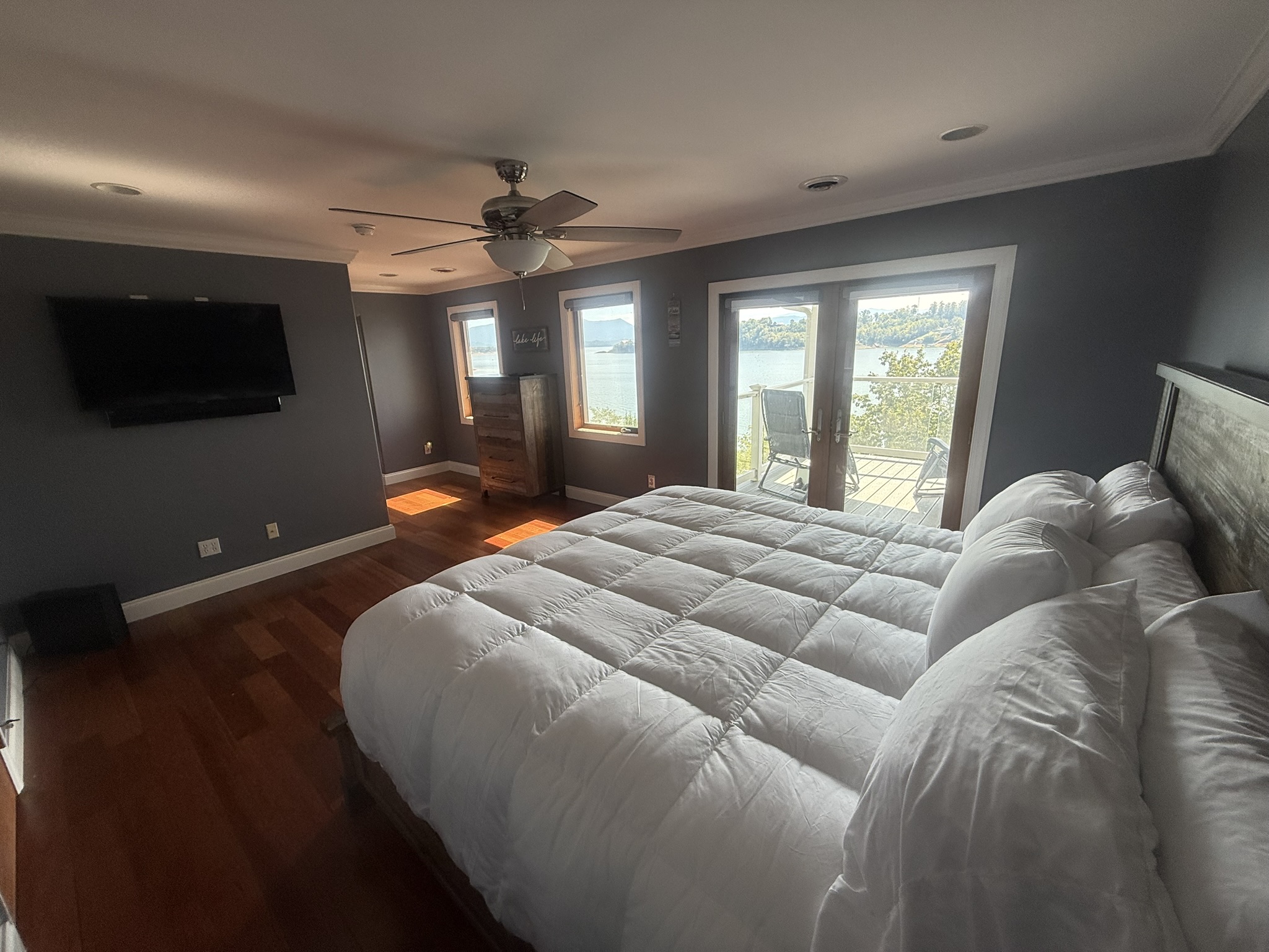 Bedroom 1 with King Bed, private covered porch, and beautiful view of Douglas Lake, Large RV, private bathroom and shower, and large closet