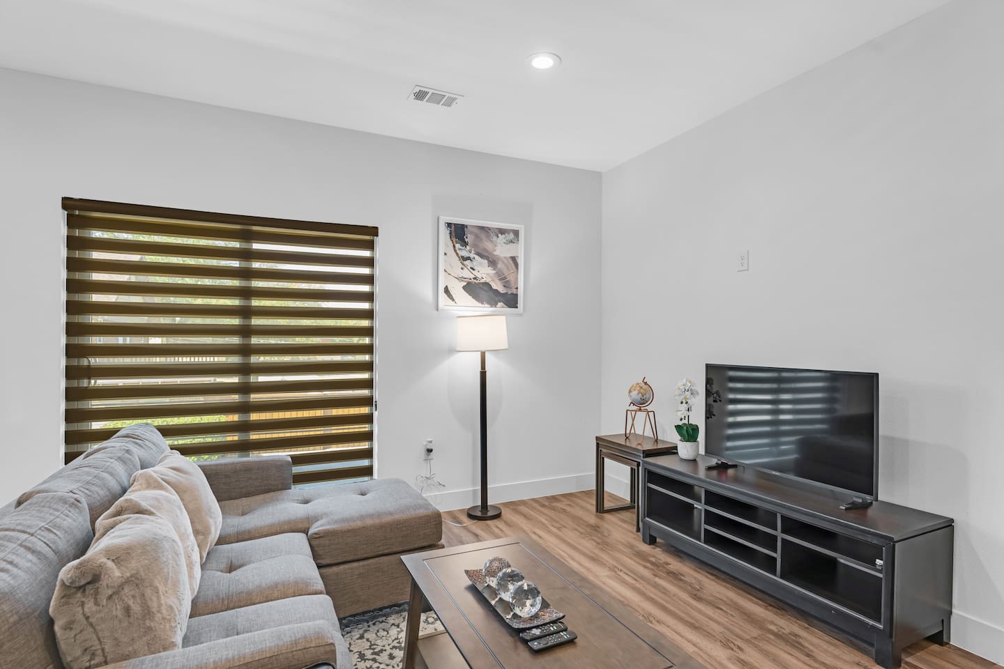 Comfortable living area featuring a sectional sofa and flat-screen TV.