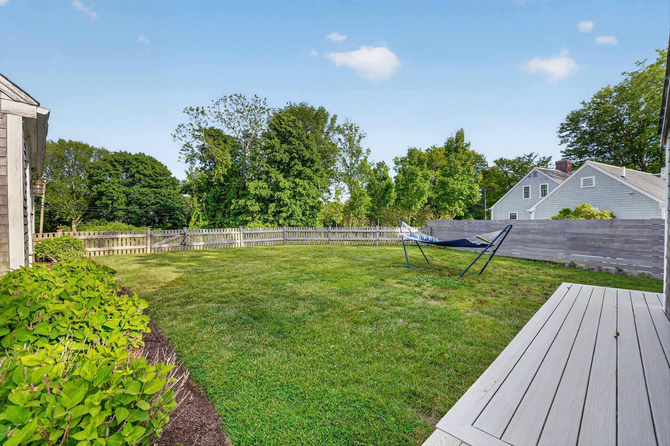 Expansive private backyard with plenty of open space for lawn games, relaxing, or family fun.