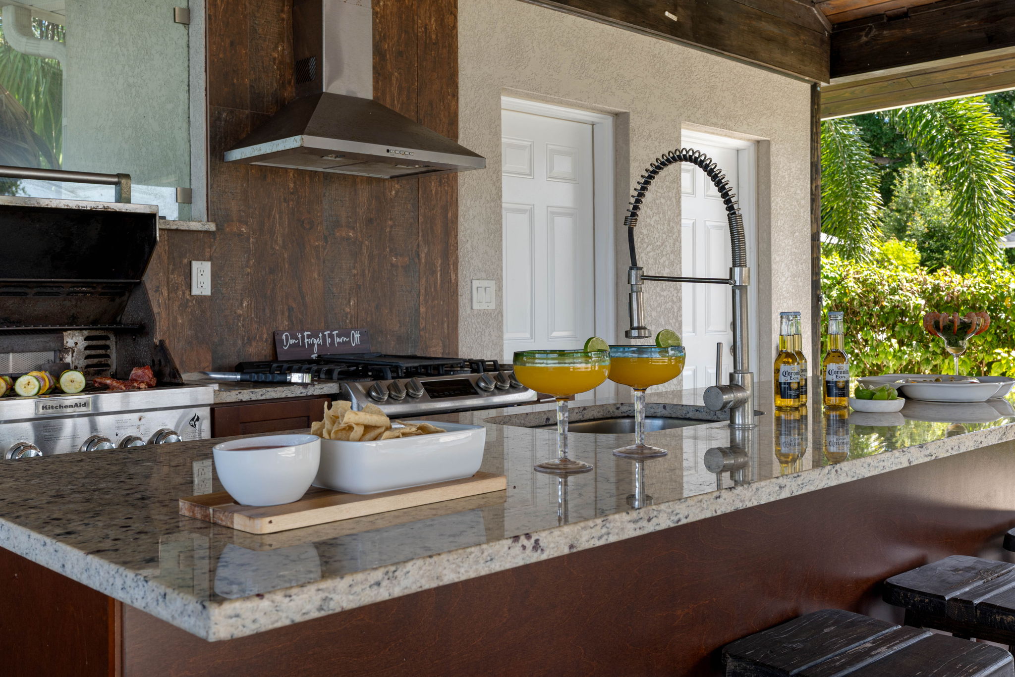 The fully equipped outdoor kitchen makes it easy to enjoy al fresco meals while taking in the scenic surroundings.