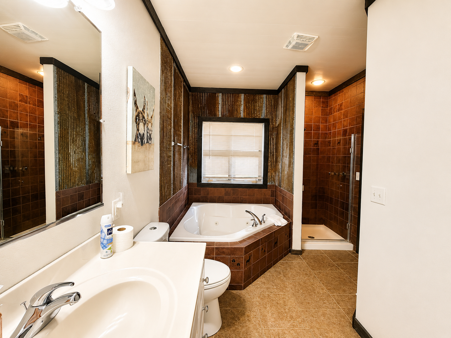 Full bathroom with a spacious vanity and corner soaking tub gives guests a comfortable place to get ready and unwind. Connected to the main floor bedroom make this convenient and easy.

