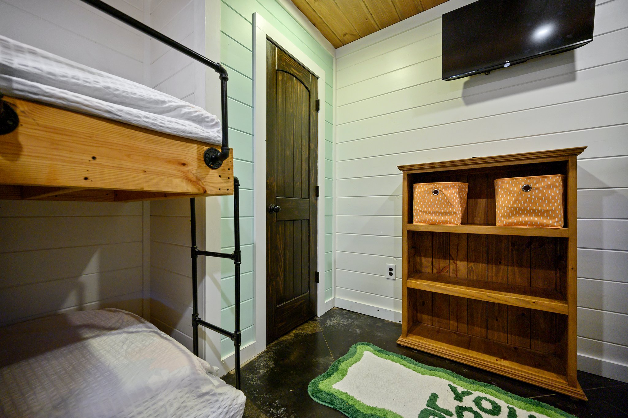 The bunk room comes with plenty of storage and a TV!