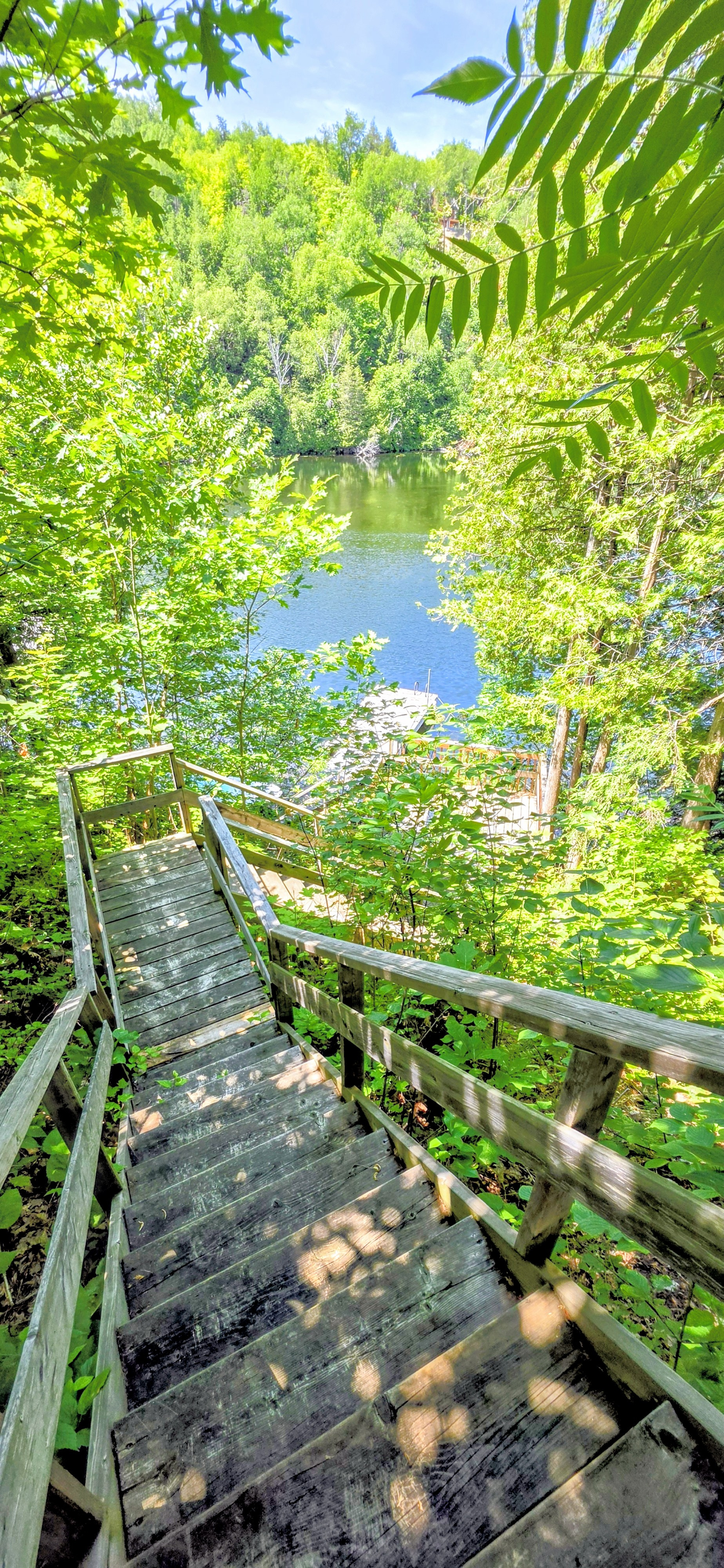 Stairs down hillside to lower deck and dock