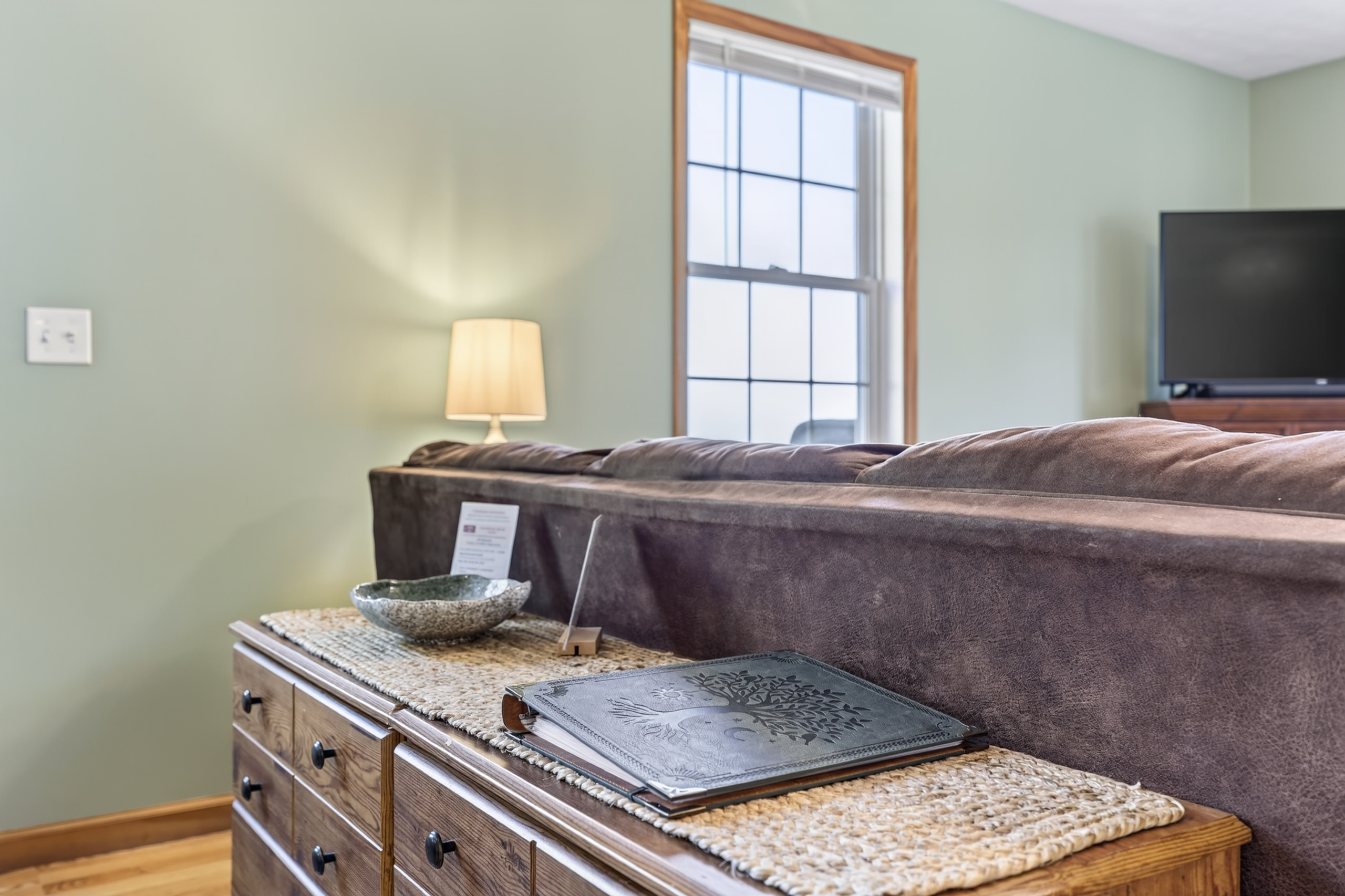 The entry way has a console table for extra storage, a key bowl, and the Guest Welcome Book with any information you might need for your stay.