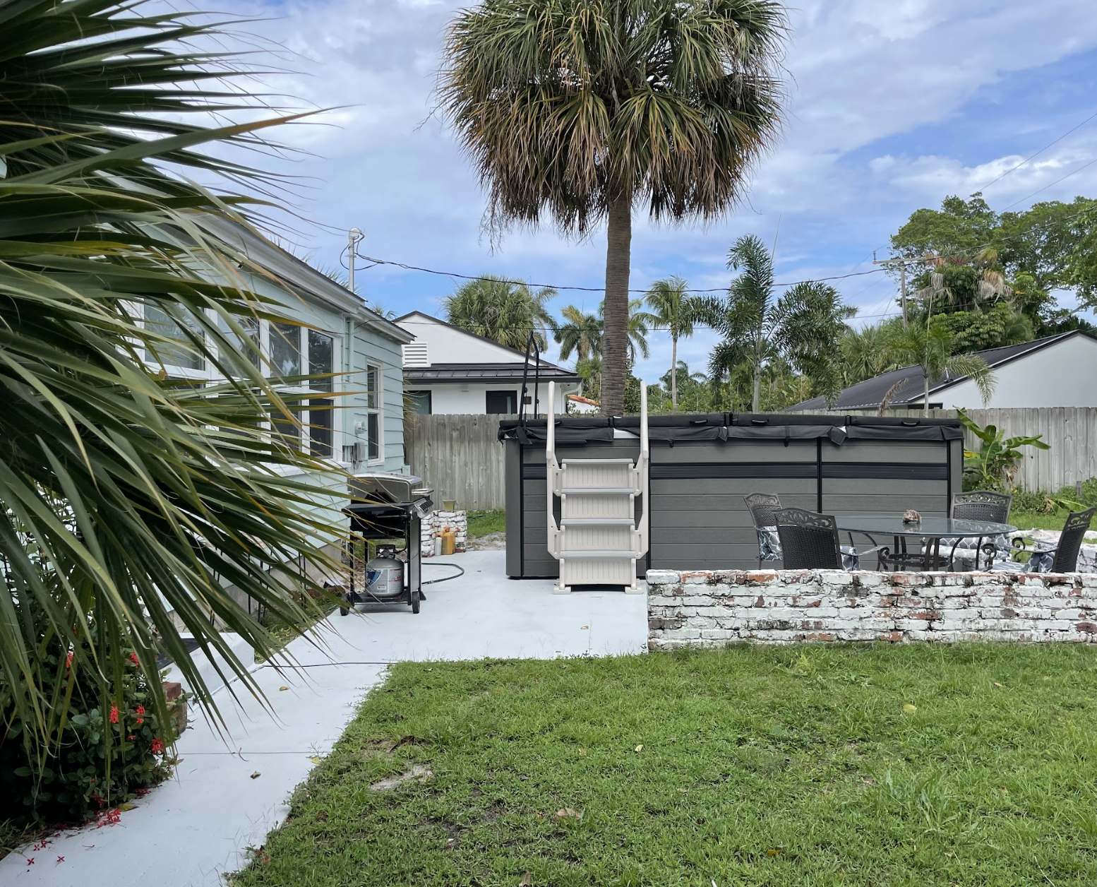 Enjoy the patio as you take in the tropical scenery next to the swim spa.