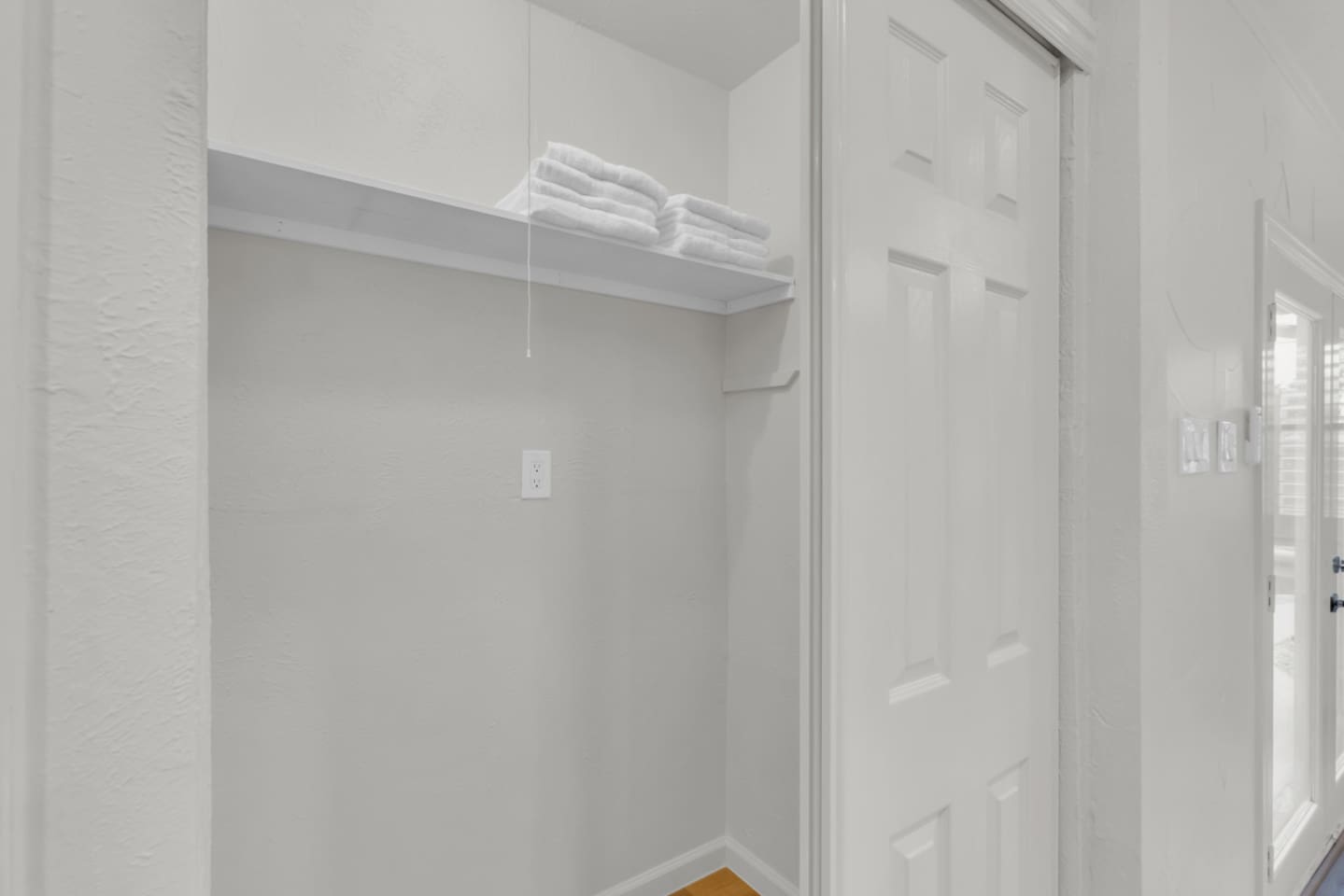 Fresh towels and essentials stocked in the hallway closet, ready for your stay.