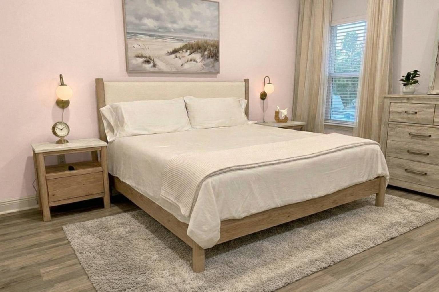 Luxurious primary suite with king bed, walk-in closet, and ensuite bath featuring double vanity.