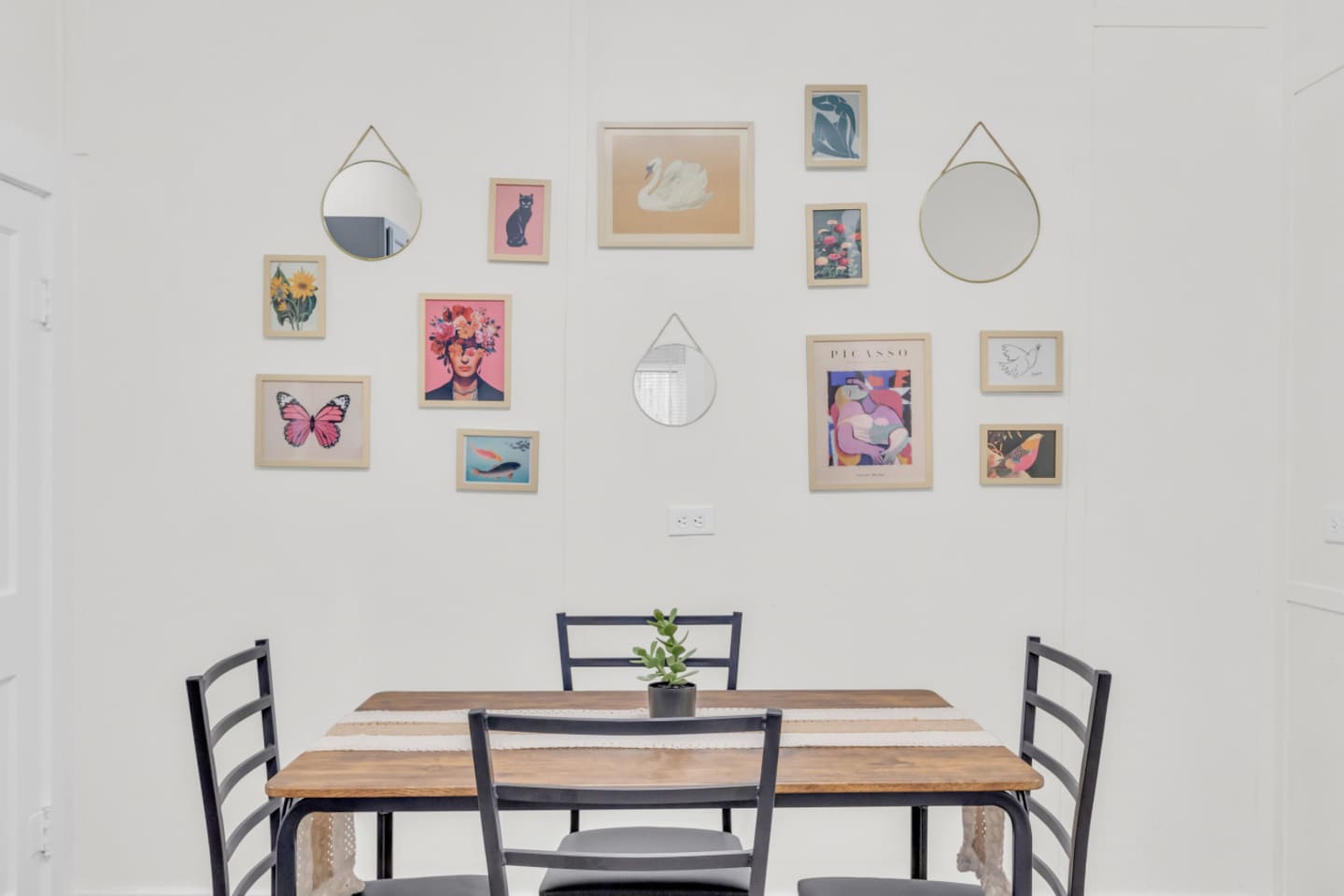 Eat-in kitchen with dining table with seating for 4 and bright natural light.