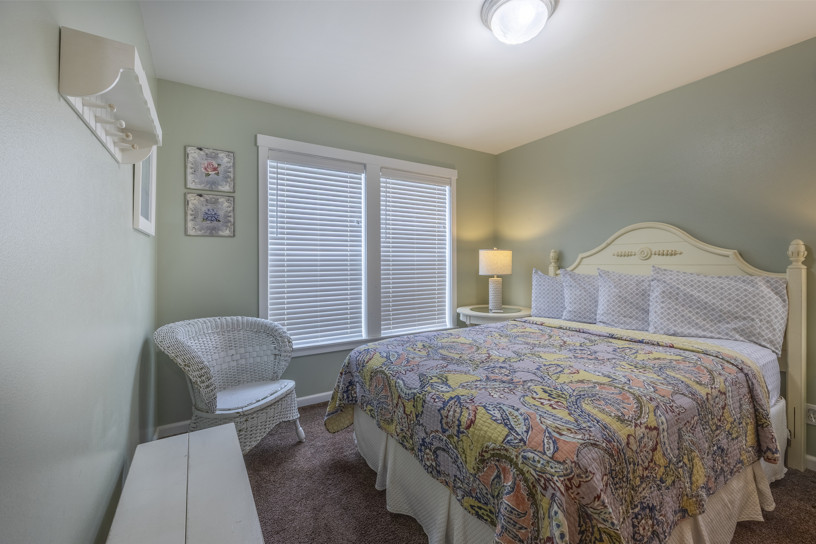 Soft pastel accents complete the queen bedroom, offering a peaceful and inviting space to unwind after a day at the beach.