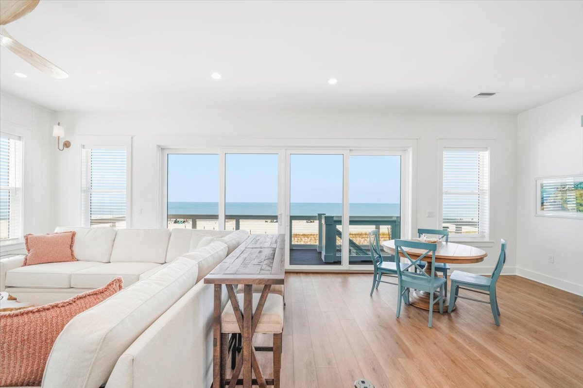 Welcome to the middle floor!  A little more casual with a large sectional, game table, small kitchen, and a balcony with stairs to the pool area.