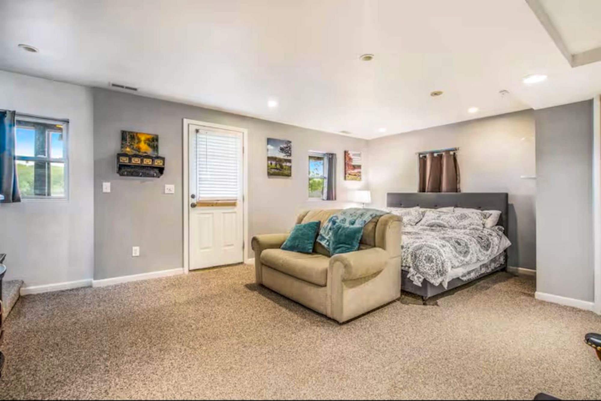 This bedroom is on the bottom level and also has an entrance to the back yard that faces the lake.  This area is a shared space if one is to use the sofa to sleep on as well. There is laundry and a full bathroom off this area. A crib is available