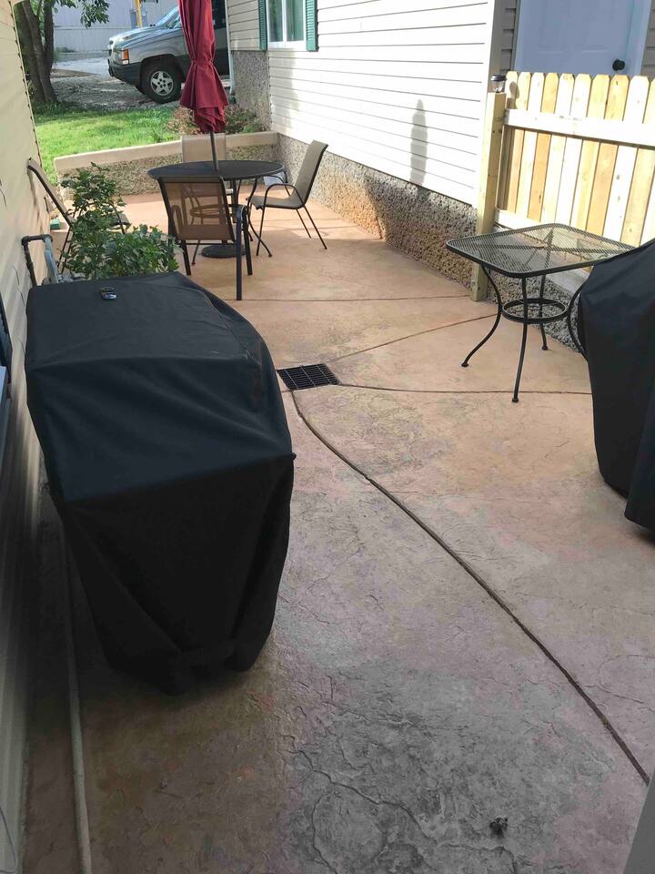 Patio area between the entrance to through the kitchen and the garage. We have both a Griddle Grill AND a propane BBQ Grill.