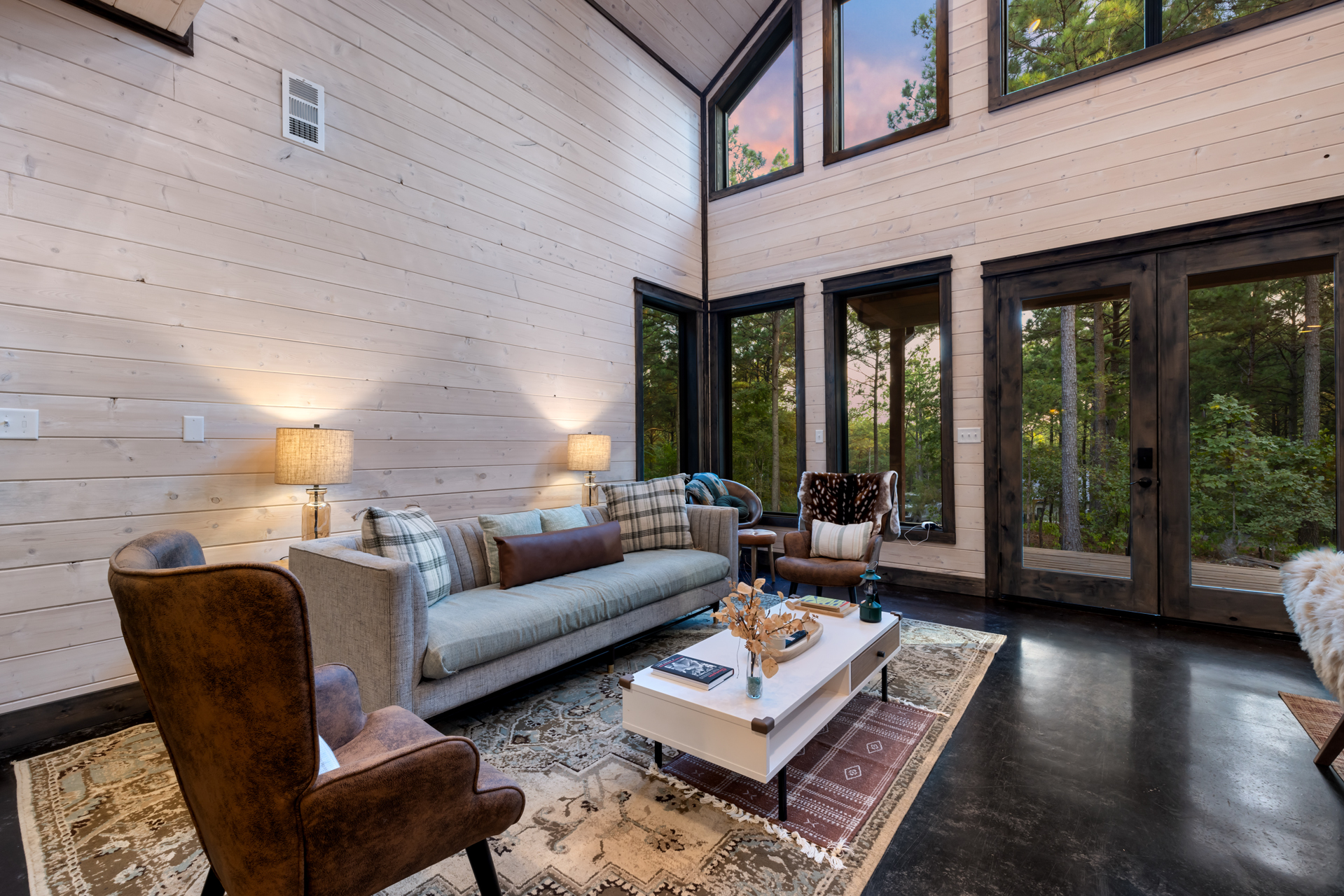 Additional seating area in the living room featuring a second sofa set placed just behind the main lounge space, offering extra comfort and flexibility for larger groups while maintaining an open, connected layout for socializing and relaxation