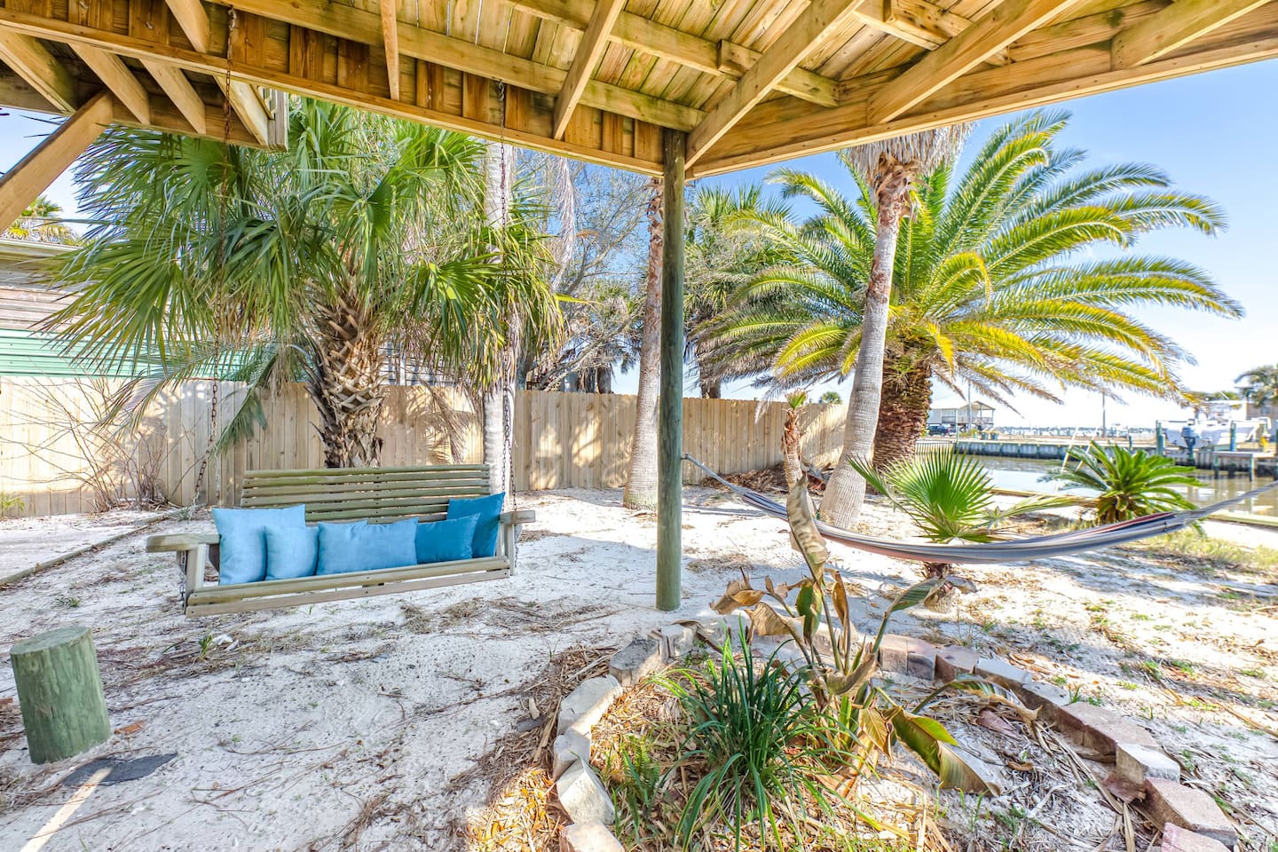 Outdoor Oasis: Relax on the swing or hammock under swaying palms, steps from the water!