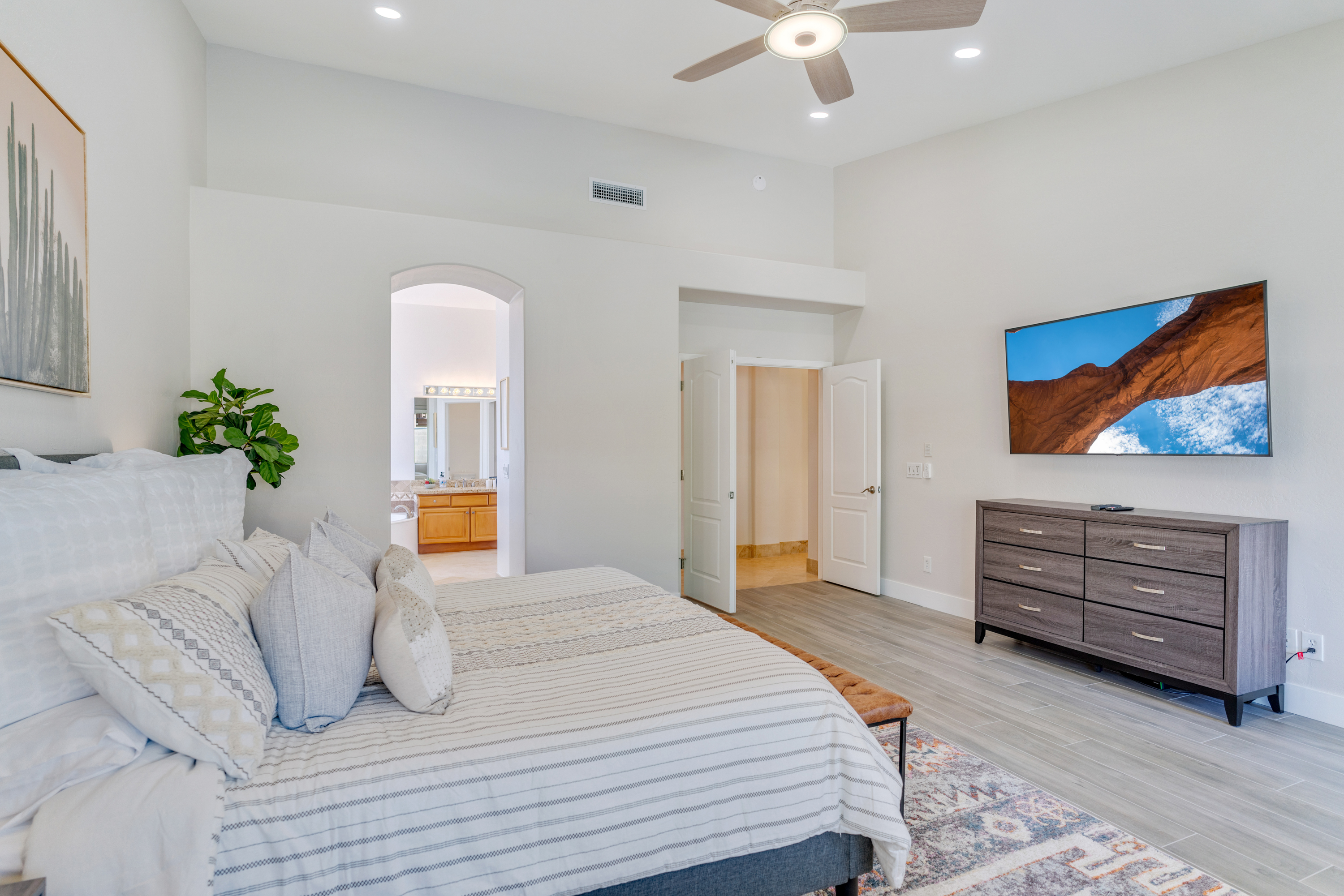 Large & bright master suite with cathedral ceilings, French doors and Smart TV.
