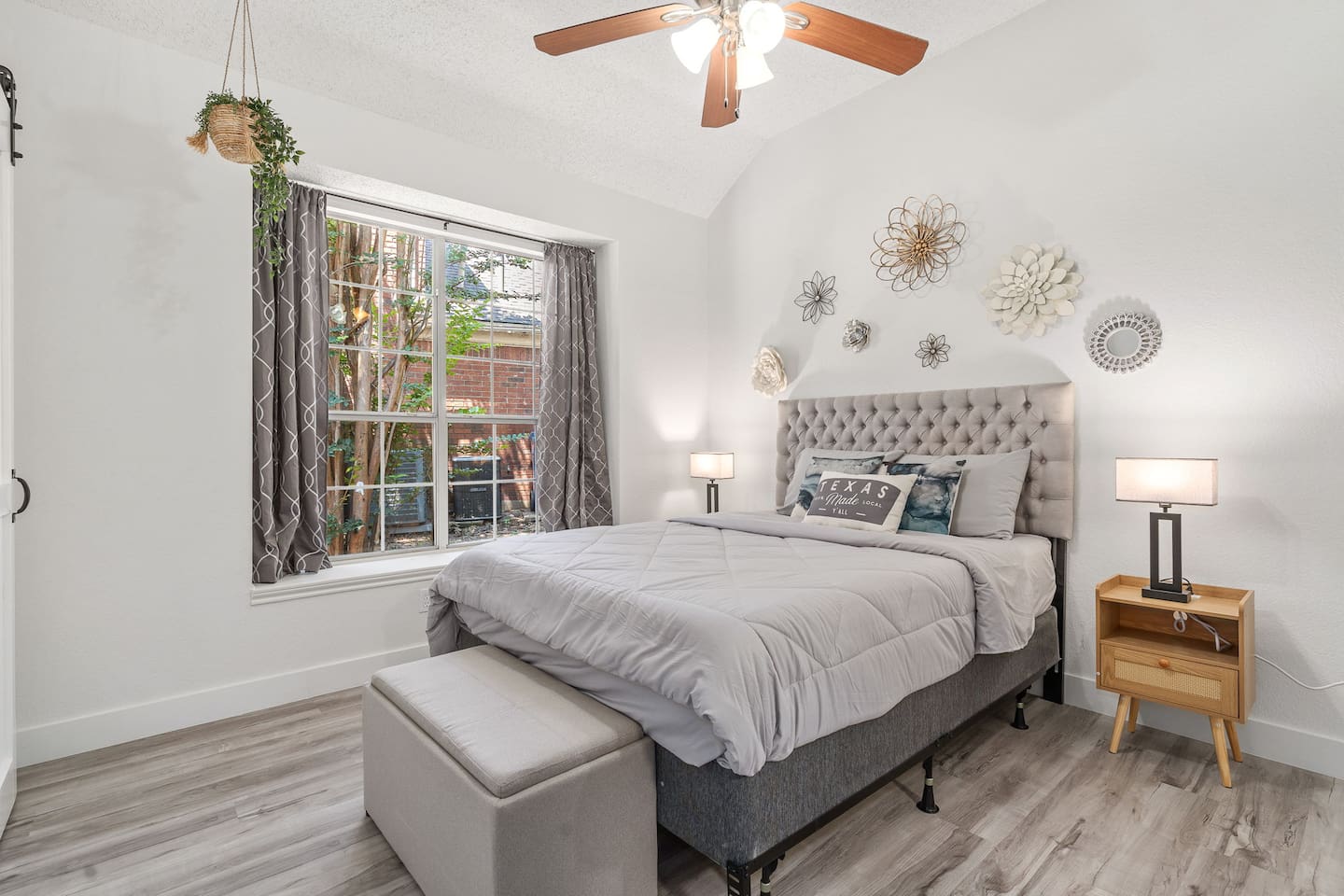 Bright and airy bedroom with queen bed, room darkening shades, and contemporary furnishings.