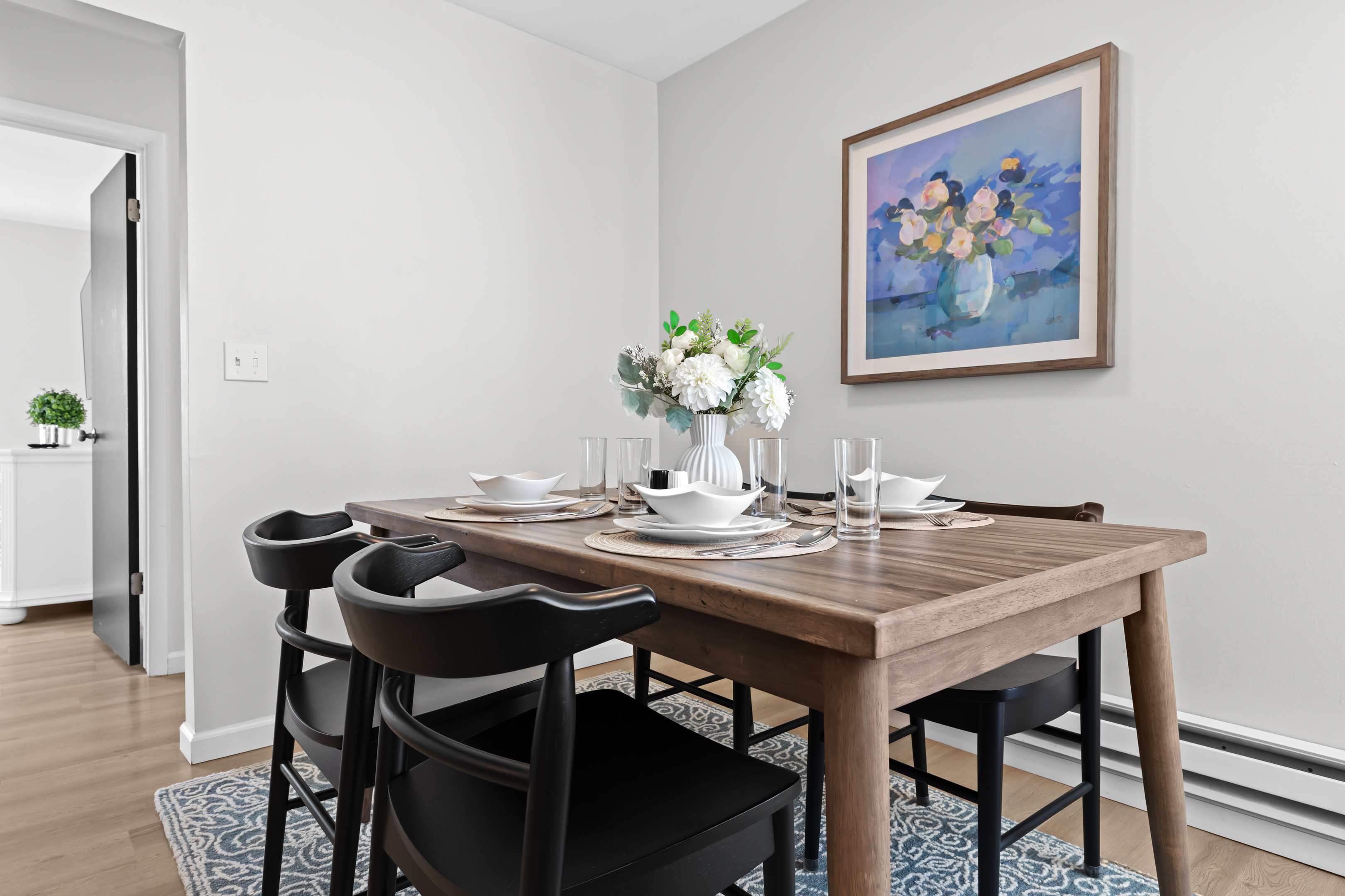 Open dining area with tasteful wall art and natural lighting.