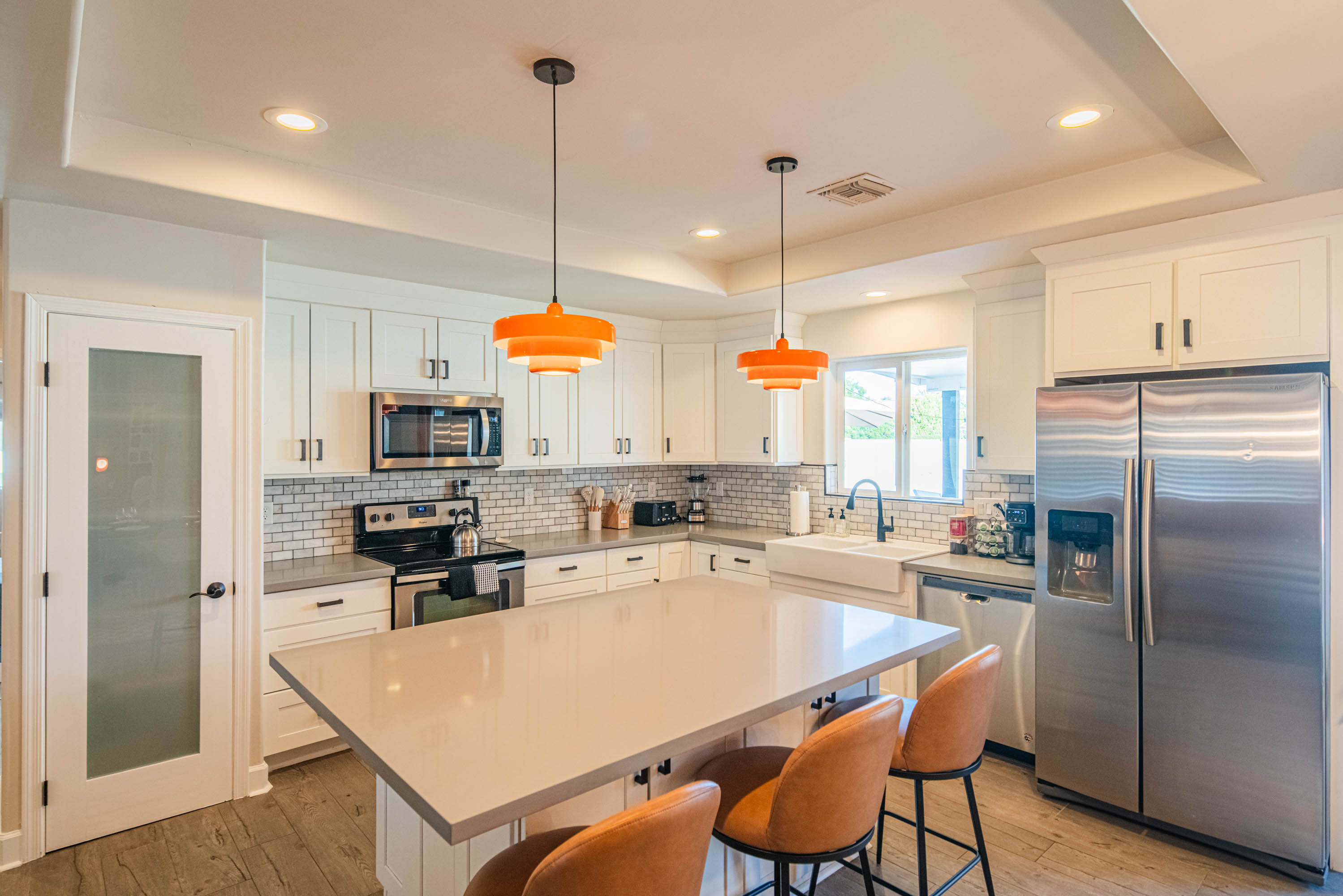 Full chef’s kitchen with stainless steel appliances, spacious counters, and island seating — perfect for cooking at home or hosting group dinners.