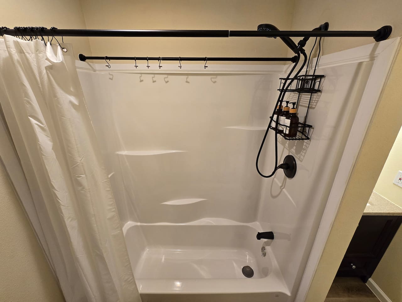 Downstairs bathroom - Shower/Tub combo. Extra rod and hooks for hanging wet swimsuits.