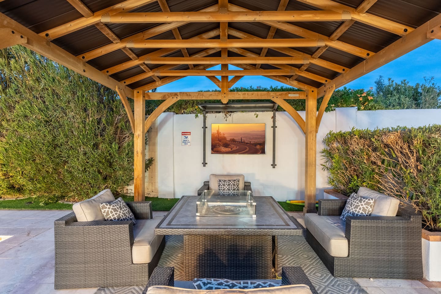 Relax beneath the pergola with TV and fire table.